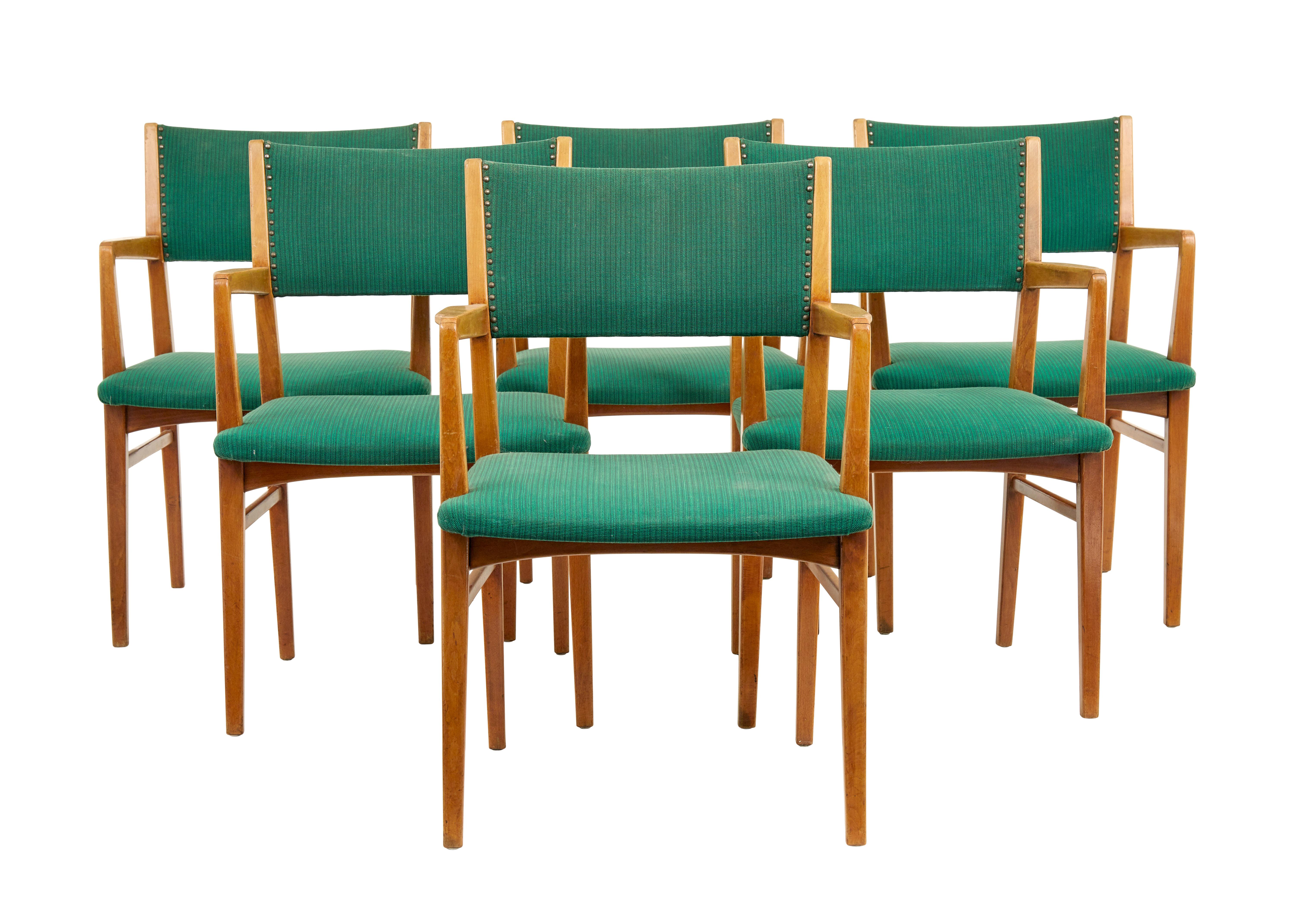 Set of 6 mid 20th century scandinavian armchairs circa 1960.

Good quality set of swedish office chairs which could now serve well as dining chairs.  Very comfortable and made in solid beech.  Upholstered in contrasting green fabric.

Surface marks