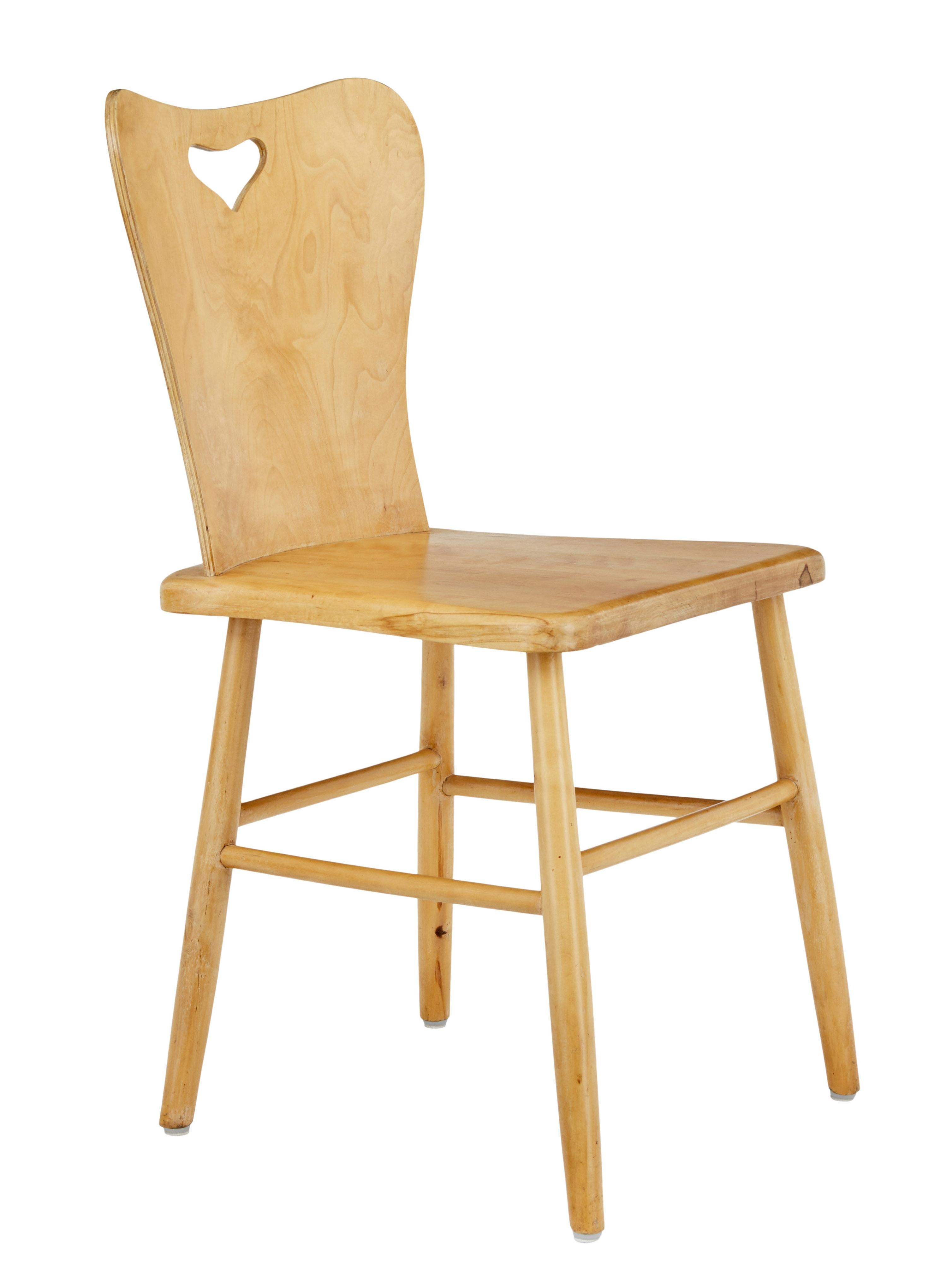 Good quality set of 6 Scandinavian design dining chairs from the 1960s.

Pine seat and legs with birch veneered back rests. Shaped backs with heart shaped handle. Turned legs united by stretchers.

Good functional chairs with elegant