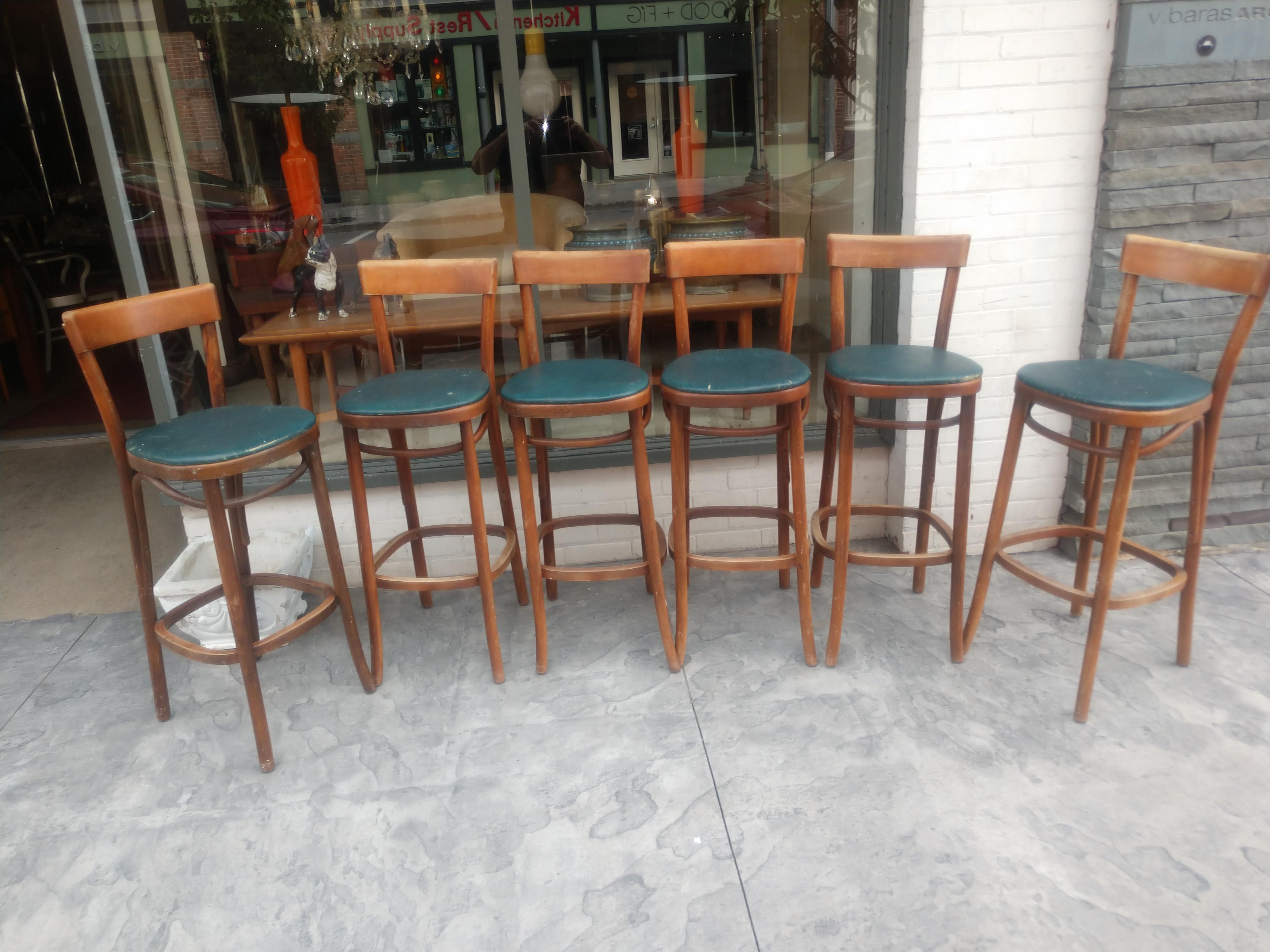 Fabulous set of original bar stools by the Thonet Bros. Two stools are tagged. Created from bentwood walnut with the original naugahide seat covers. In excellent vintage condition with minimal wear. The wood has been cleaned up since the pics were