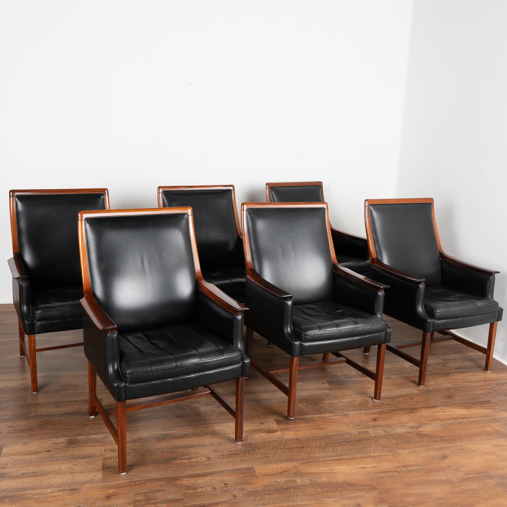 Attractive set of six mid century high-backed dining chairs/armchairs by Torbjørn Afdal.
Made of solid rosewood, seats and back upholstered in black leather. Seats (non-removable) each have four decorative seams.
Manufactured at Nesjestranda