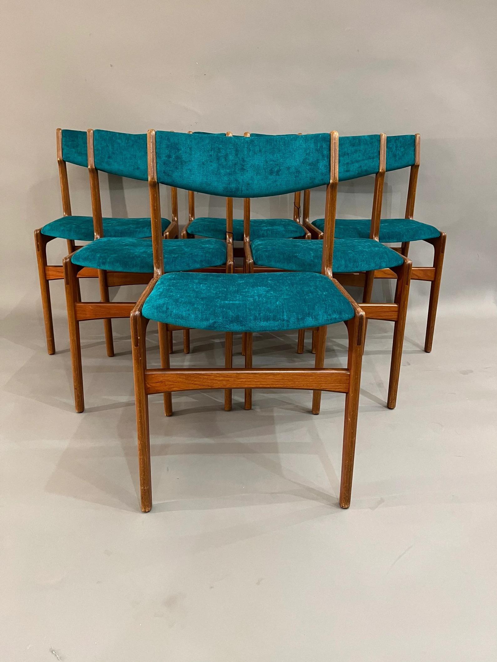 Set of six 1960’s Danish mid century dining chairs designed by Erik Buch for O.D. Møbler. Elegant frames support square seats and scooped backs upholstered in a brown basketweave fabric.
Curated Mid Century teak dining chairs with the new teal