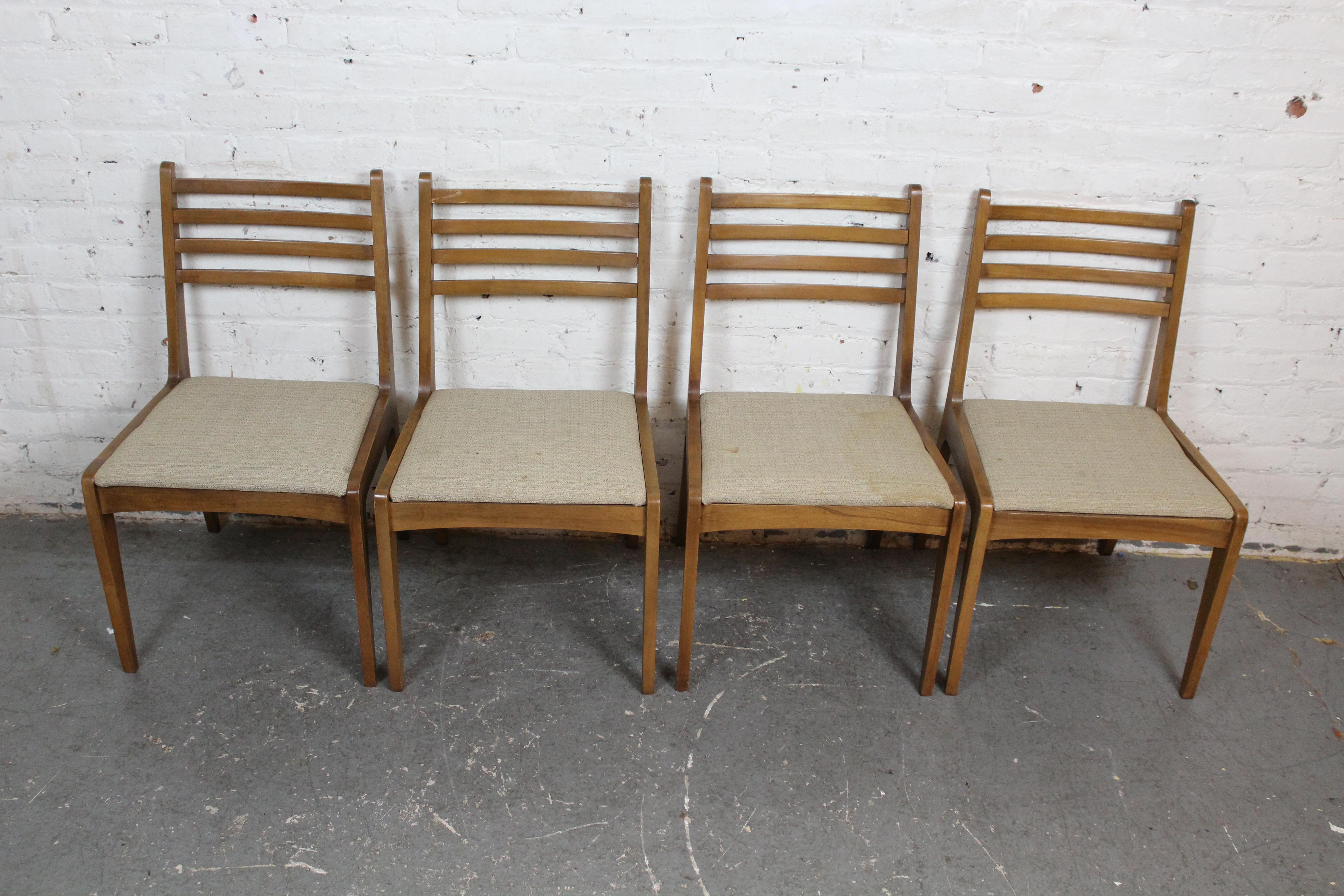 Bring home the charm of American Mid-Century Modern design with this funky set of dining chairs built by the B.F. Huntley Furniture Company of Winston-Salem, North Carolina. Borrowing cues from the pioneering modernist furniture of Heywood