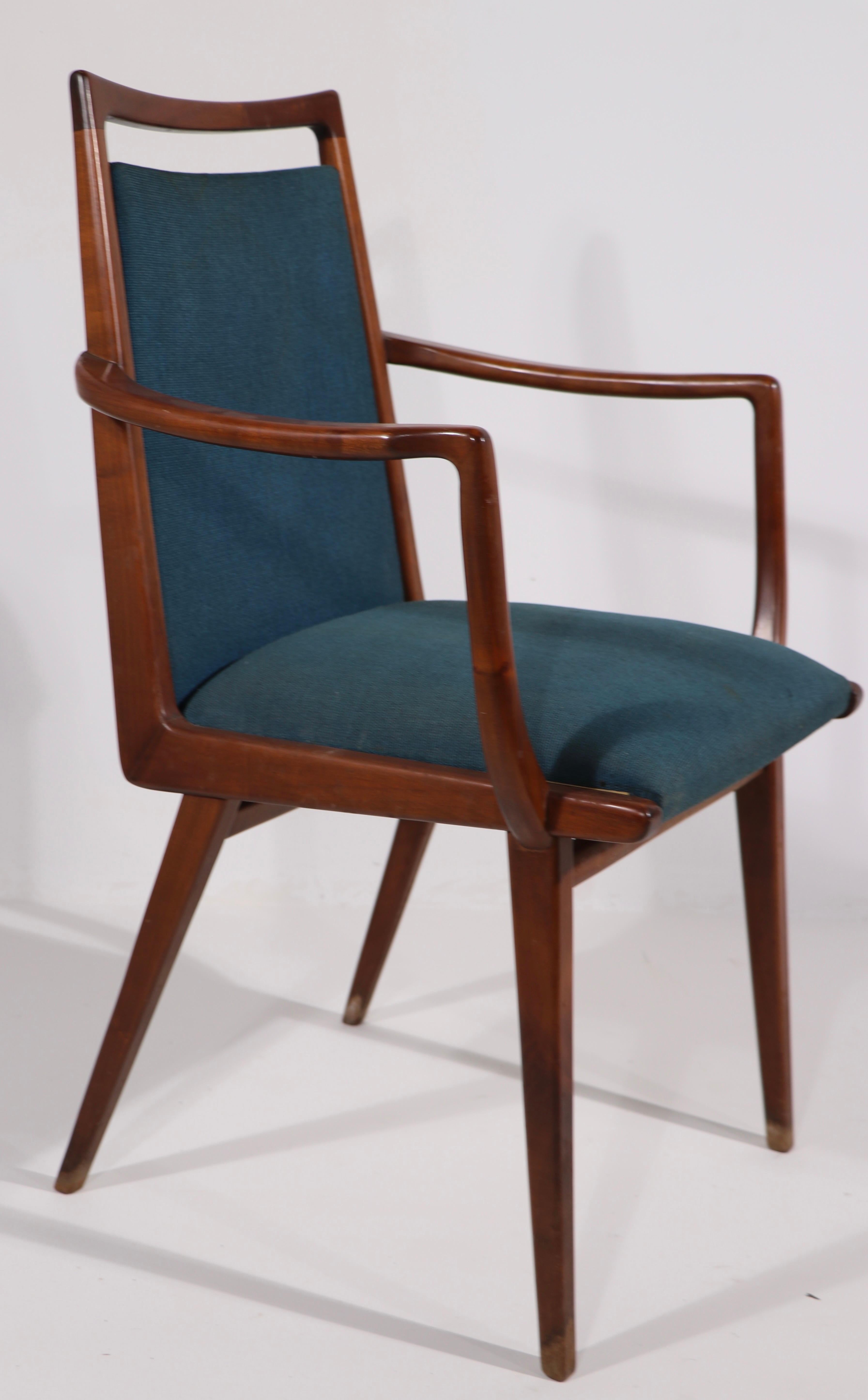 Sophisticated sculptural set of mid century dining chairs, made in Germany, for Casala. The set consists of 2 armchairs, and 4 side chairs. The solid wood frames are all in very good, original condition, sturdy, light and ready to use. The fabric