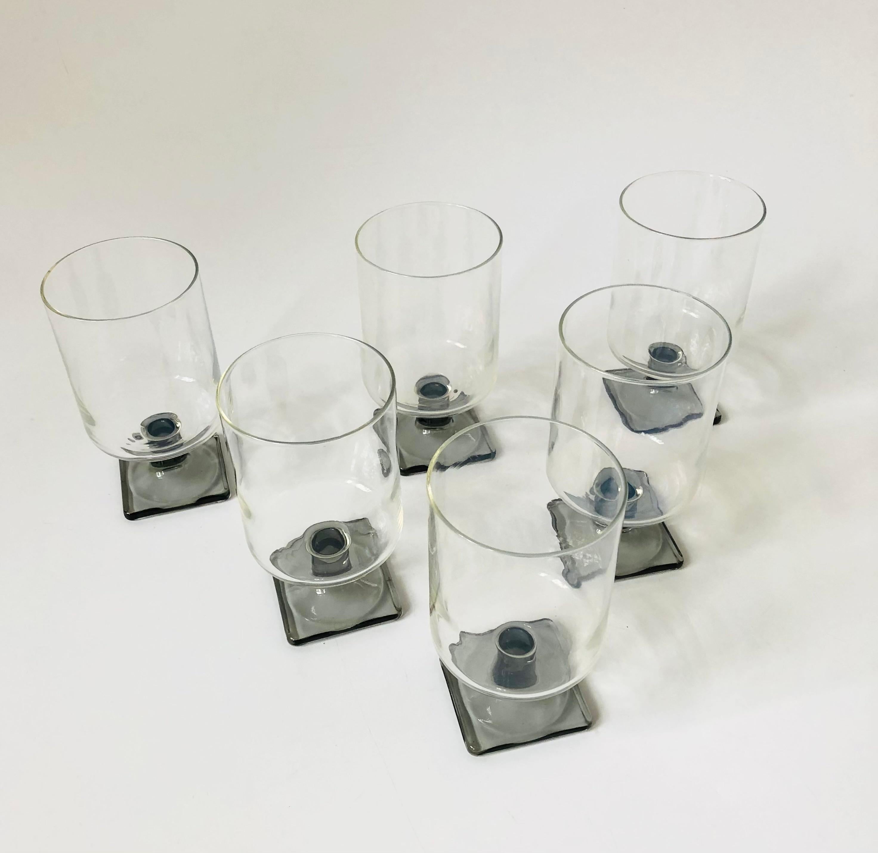 A set of 6 mid century cocktail glasses. Clear cylindrical tops contrast nicely with the gray square bases. Made in the Nordic Midnight pattern by Federal Glass. Perfect for wine or cocktails.
 