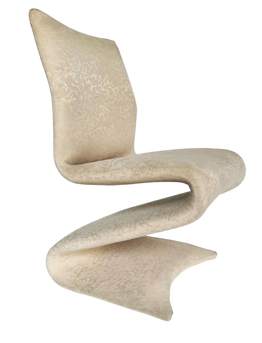 A stunning vintage set of six dining chairs after Verner Panton. These chairs feature a sculptural design. Chairs will eventually need to recovered. Upholstery is original and in fair condition.