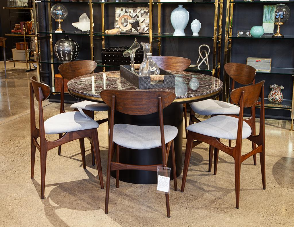 Introduce iconic Scandinavian design to your dining space with this set of six Mid-Century Modern dining chairs. Crafted in Denmark in the 1960s and inspired by the renowned designs of Hans J. Wegner, these chairs feature beautiful teak frames that