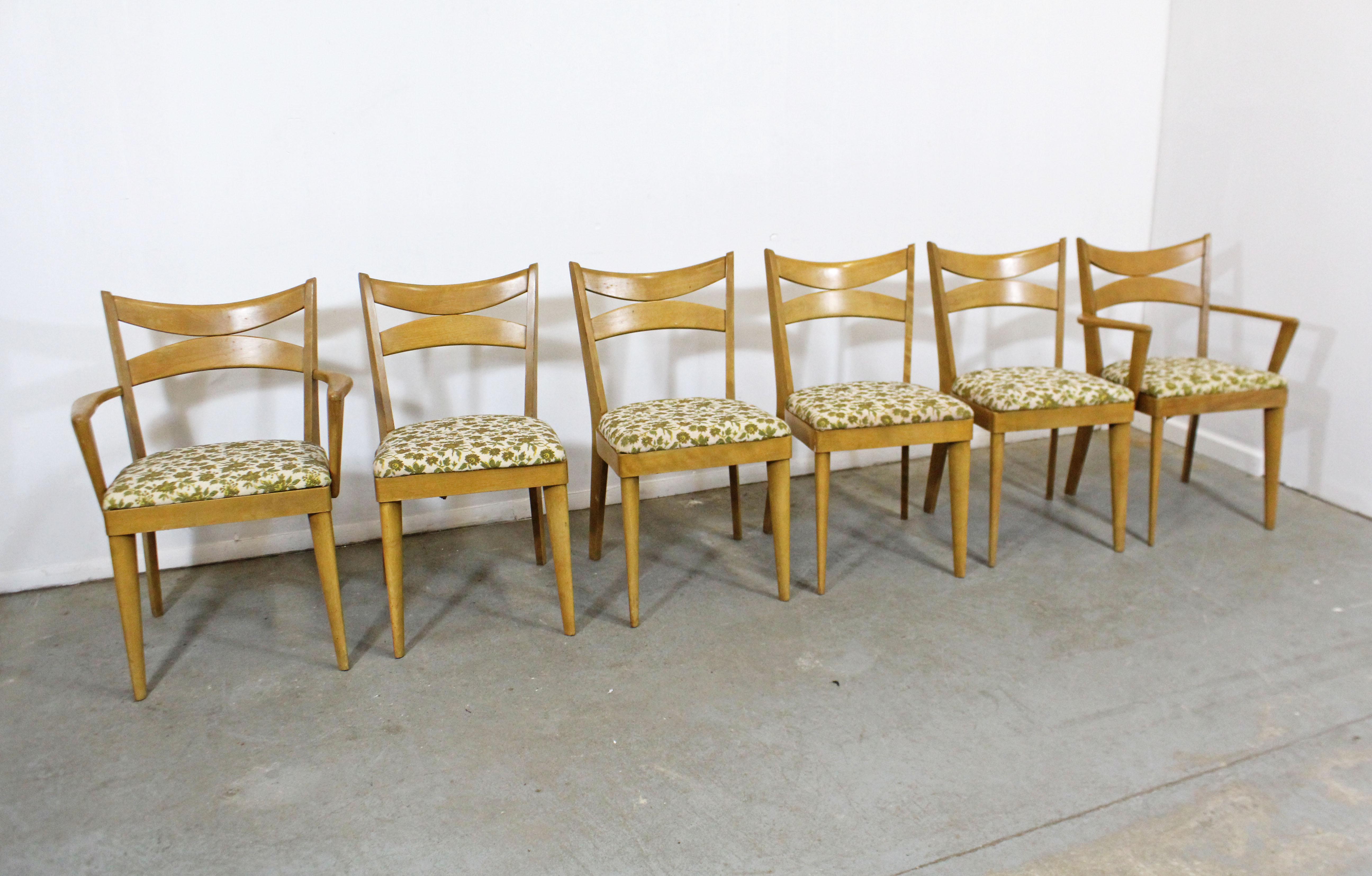 What a find. Offered is a set of 6 Heywood Wakefield dining chairs with floral upholstery in a wheat finish. The set is in decent condition, showing age wear, including surface scratches, stains. They can stand to be refinished and reupholstered.