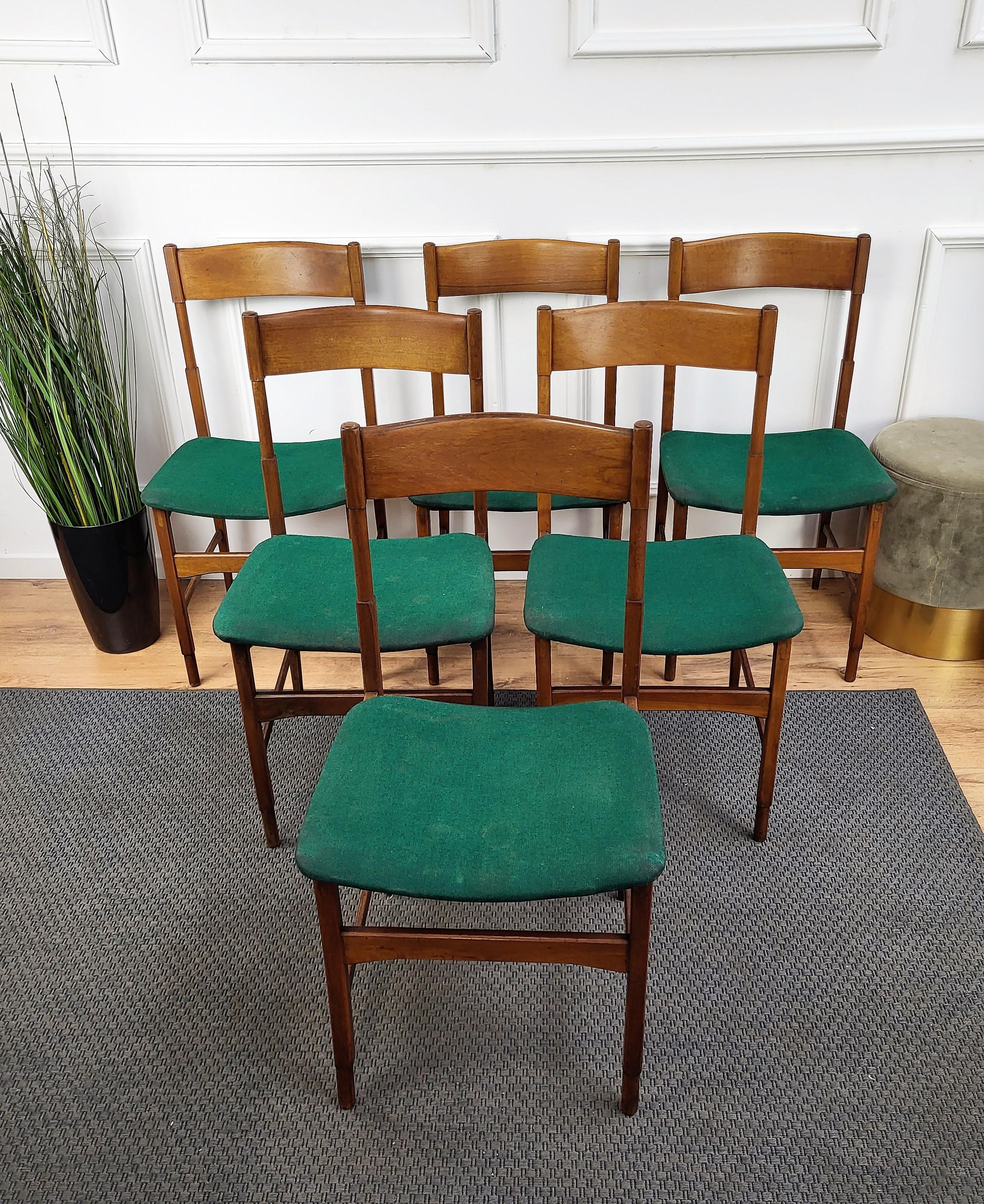 Beautiful and stylish Italian Mid-Century Modern set of 6 dining chairs, with greatly worked and shaped wooden structure and fabric upholstered seat. The unique and typical design, with the clean geometric shape and decoration enrich the natural
