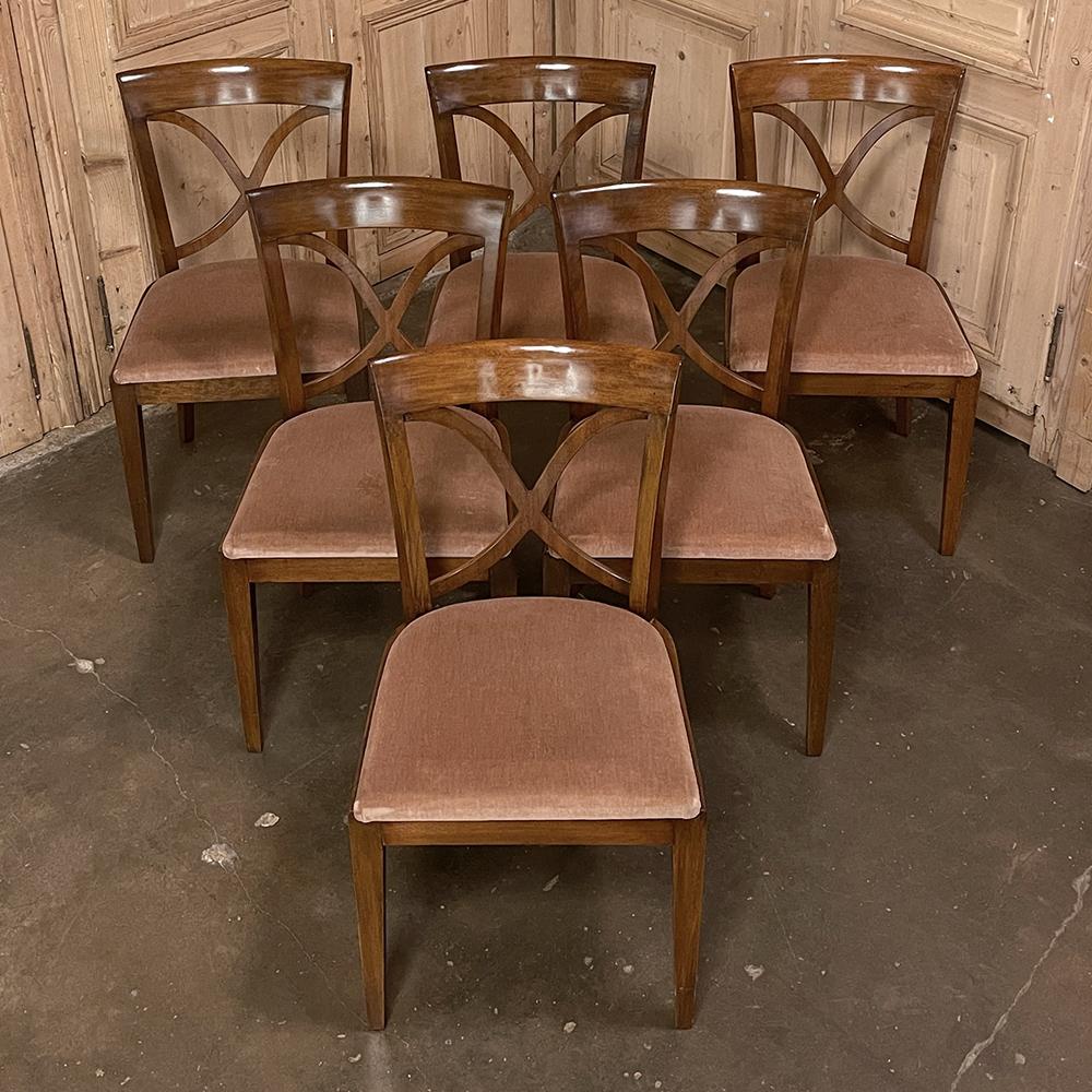Set of 6 Mid-Century Modern mahogany dining chairs by De Coene features generous seats and tailored, contoured seatbacks with architecture inspired by the Directoire period. Comfortable seats include generous seat backs and seats, upholstered in