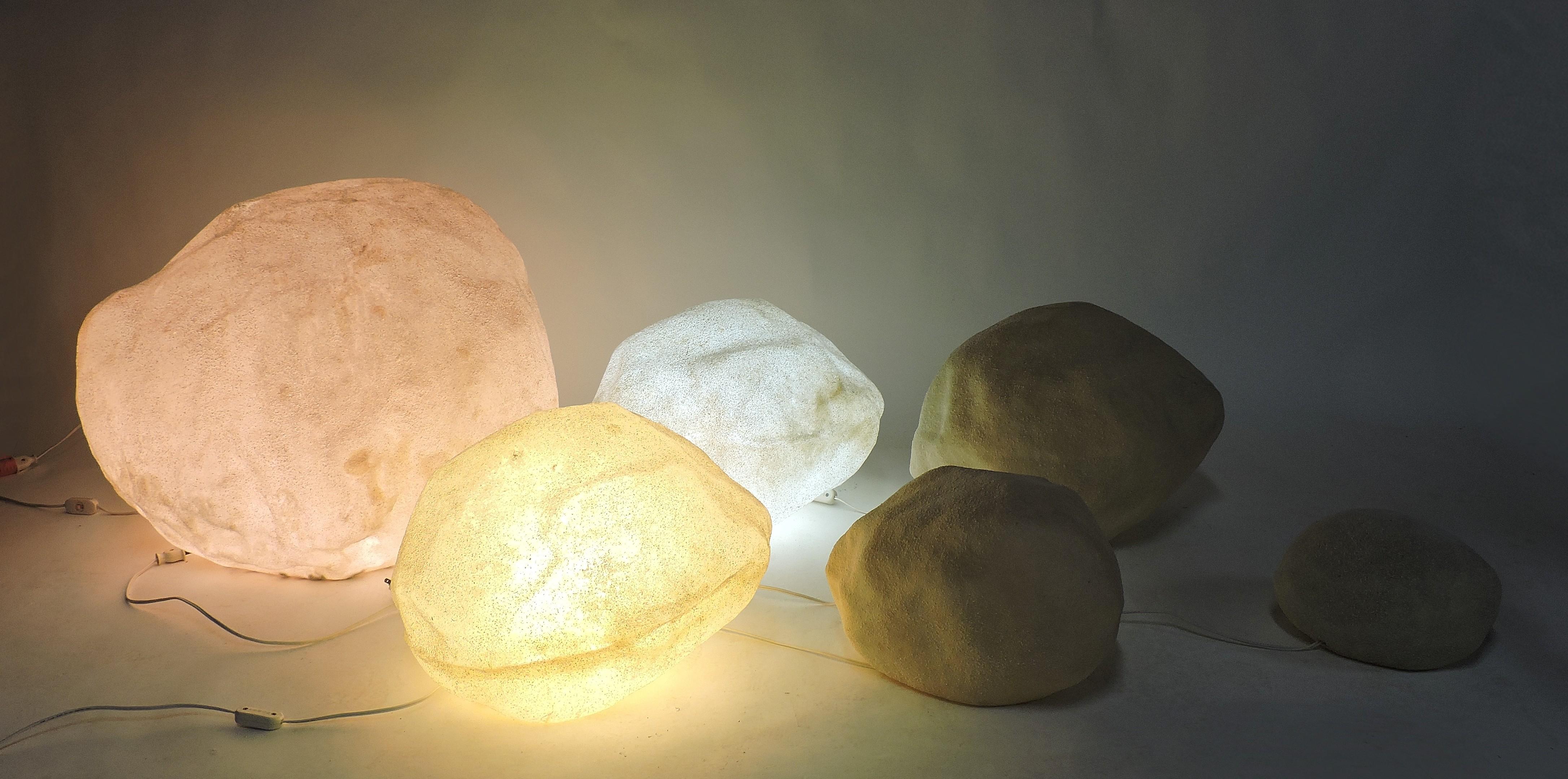 Very cool set of six luminescent moon rocks designed by Andre Cazenave and manufactured in Italy by Singleton in the 1970s. These lamps are made of translucent resin with marble powder inclusions and glow with a soft ambient light when lit. This