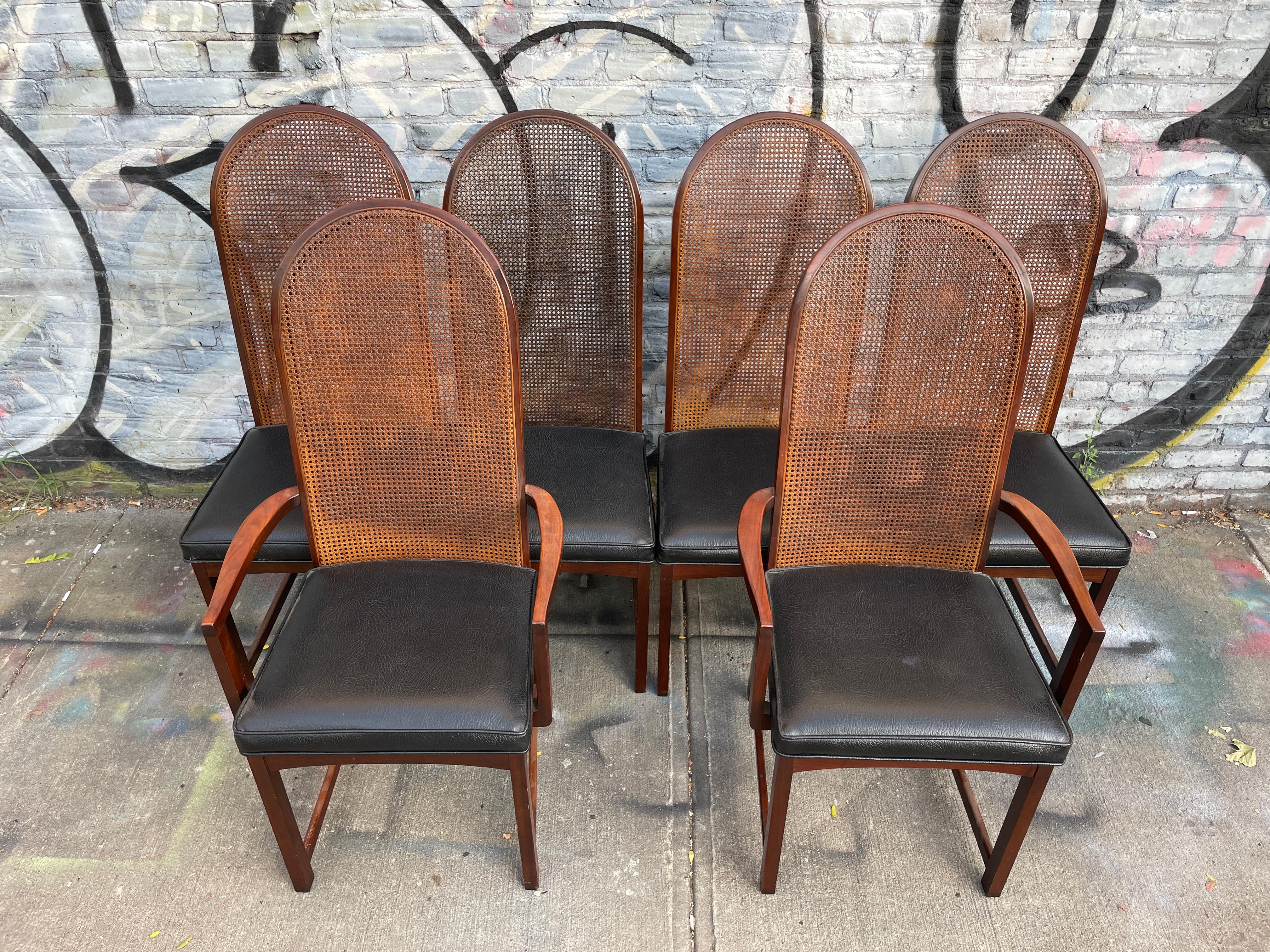 Beautiful set of 6 Milo Baughman high curved back cane dining chairs. (4) Of the chair have no arms and (2) chairs have arms - all have all the same black vinyl faux leather upholstery. Beautiful simple design very comfortable. Very easy to