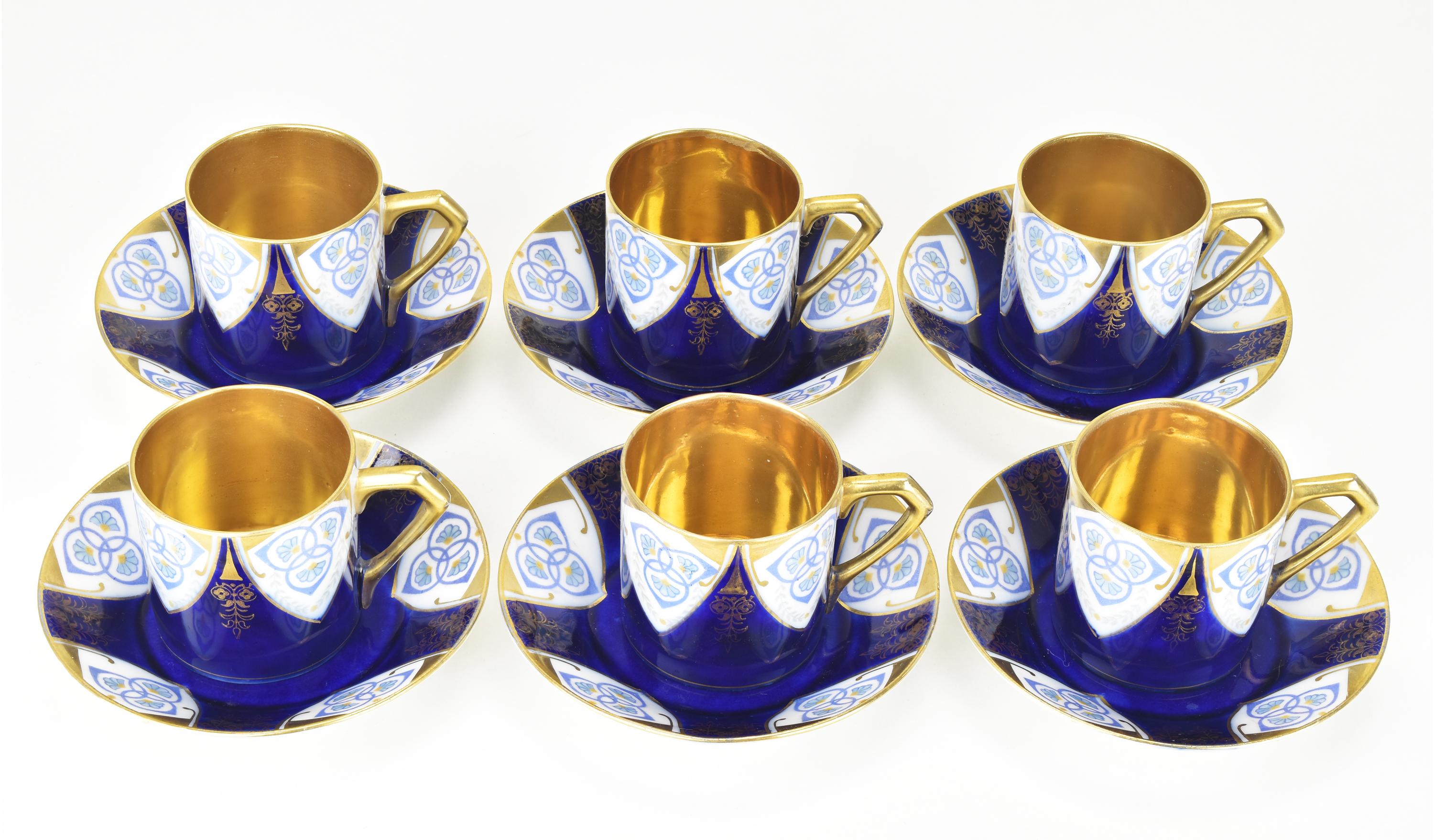 This set is made of fine white porcelain, and each cup and saucer is decorated with a unique secessionist pattern which reminds on designs by Joseph Maria Olbrich. 
The pattern feature stylized floral and geometric designs in cartouches on a cobalt