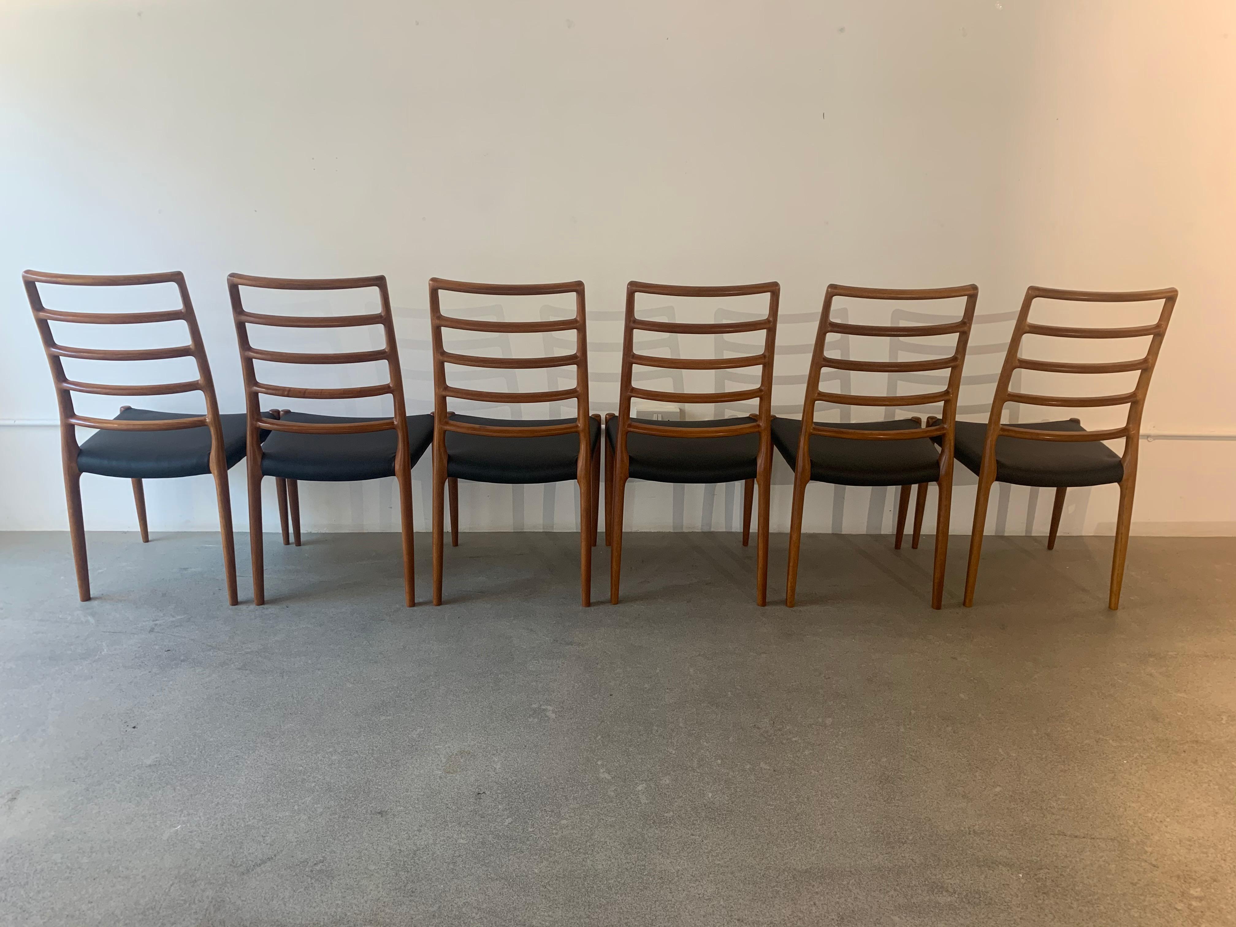 A wonderful set of 6 rare Danish model 82 teak dining chairs which are the taller five-rung ladder-back version designed by Niels O. Møller for J.L. Møllers Møbelfabrik. The Model 82 chairs are one of the rarer designs, most elegant and well