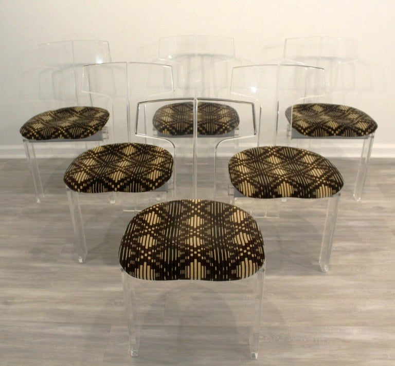 From Le Shoppe Too in Michigan, this sculptural set of 6 lucite chairs are detailed with neutral, patterned velvet seats and a reinforced, riveted silver cross bar. In good vintage condition.

Dimensions: 17 W x 19 D x 32.5 H Seat Height: 18.25