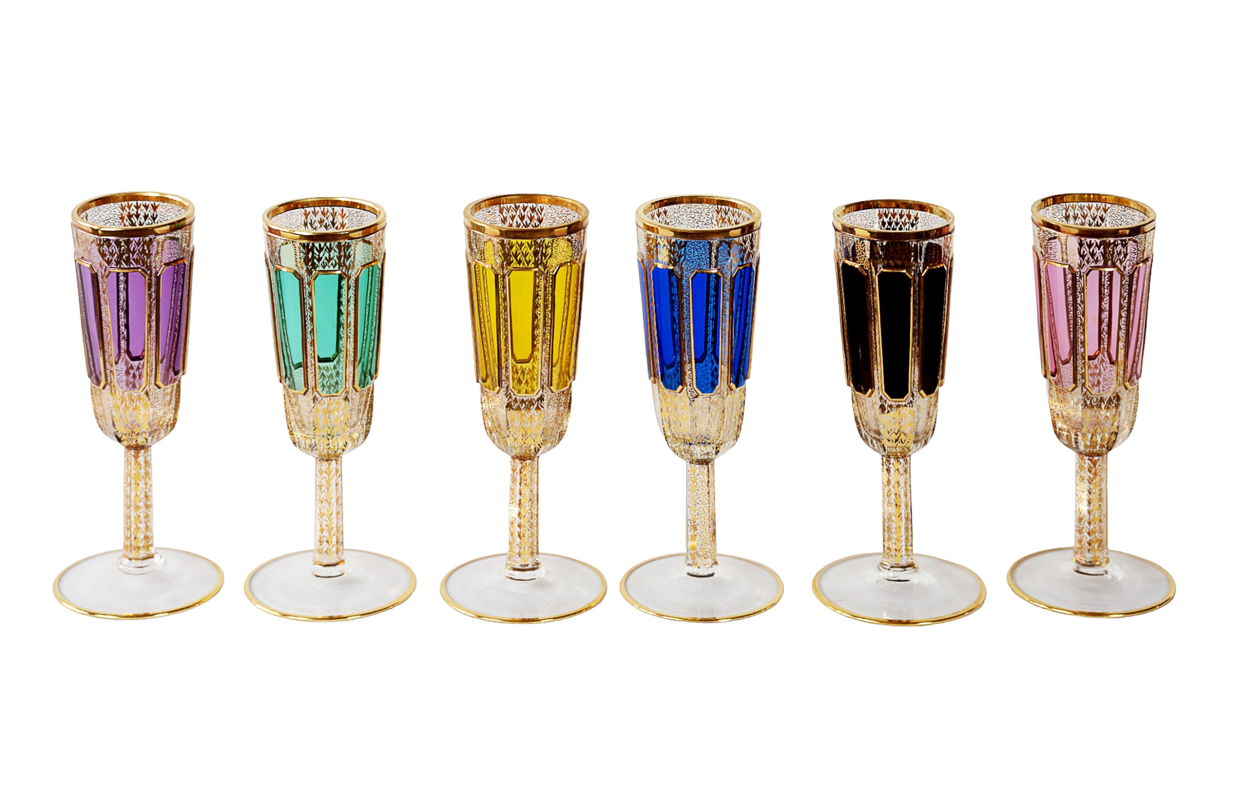 The set of 6 pcs. Moser Bohemian hand made champagne flutes/glasses.
The base of each glass is transparent, decorated with different color glass, gilt trims and gold pattern through the glass.
Very good/excellent condition.

  