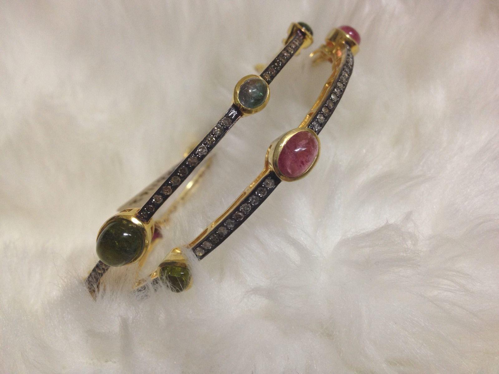 This set of six hinged bangles consists of:

Diamond- 5.88cts
Diamond type: Pave diamonds
Diamond color: White 
Metal: Silver
Metal Purity: Sterling Silver or 92.5% Pure silver
Color of Metal- Oxidized silver and gold plated
Gemstone- Natural