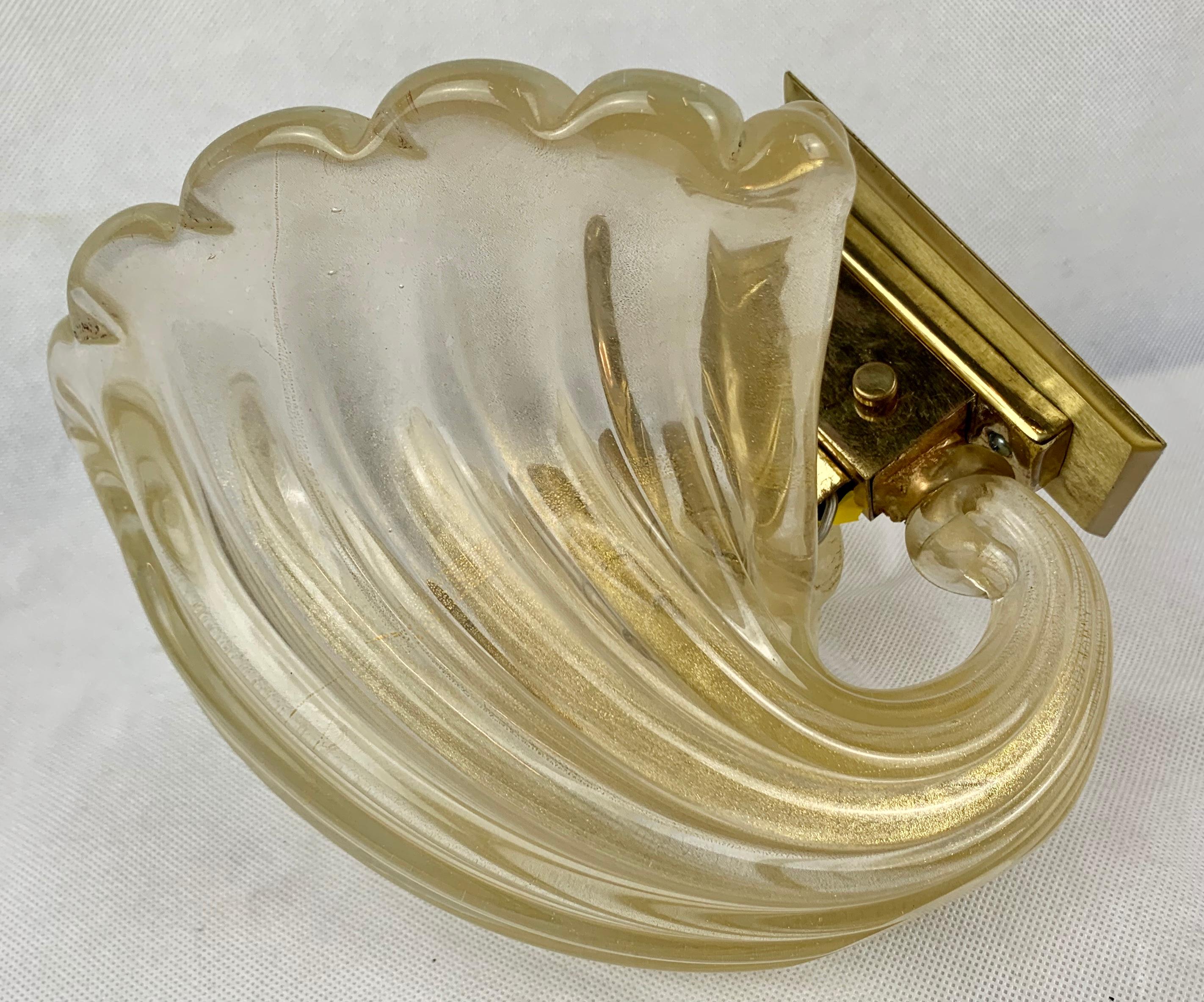 Set of six 1960's Murano Aventurine gold flecked glass cornucopia shaped wall sconces. Each one hand blown and slightly different in their uniqueness. The fluted body of the sconce flares upward to a scalloped edge. The style of each fixture