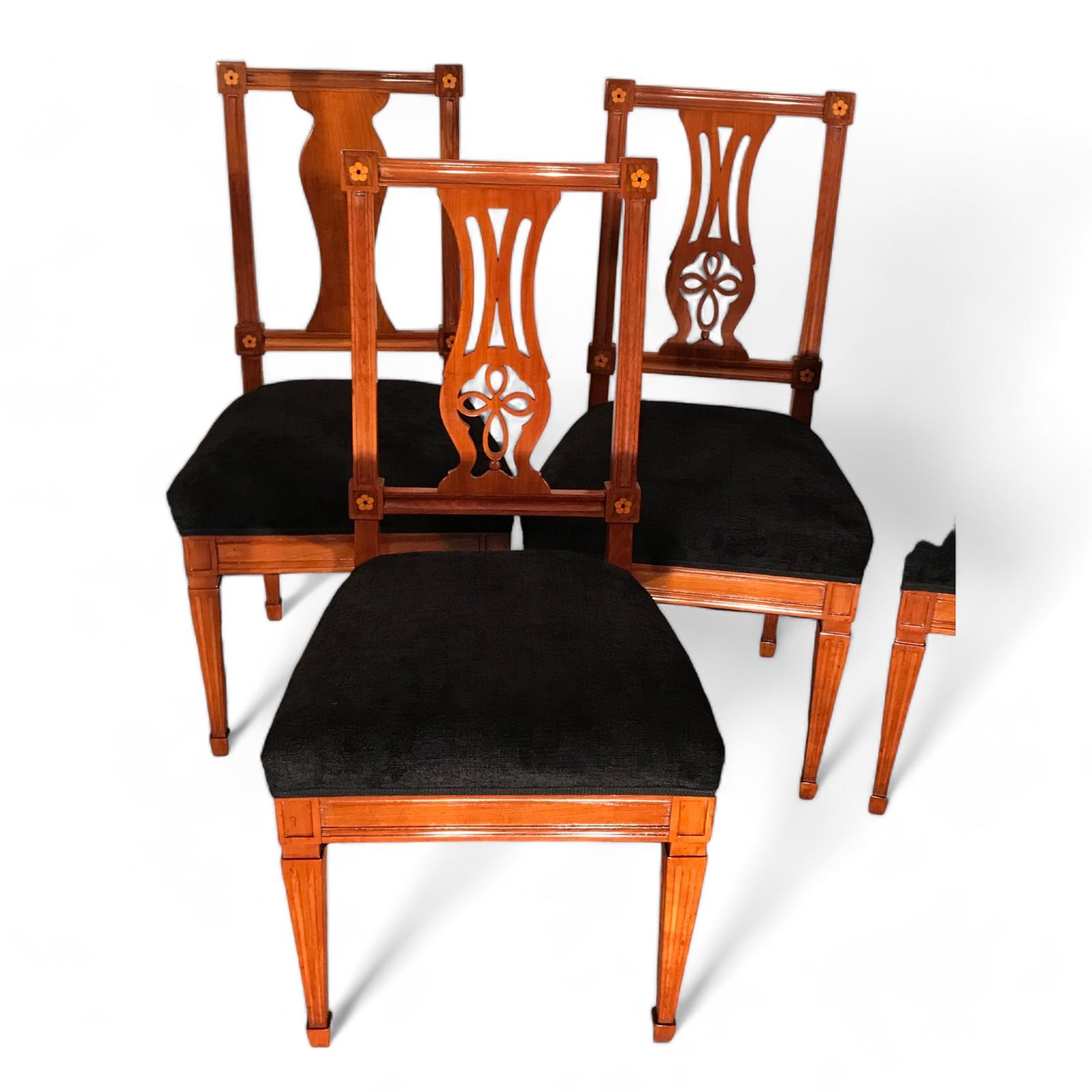 Set of Six Neoclassical Chairs
Discover a rare find with our exquisite set of six Neoclassical chairs originating from around 1800’s Southern Germany. Crafted from cherry wood veneer adorned with intricate inlaid rosette decor, these chairs exude