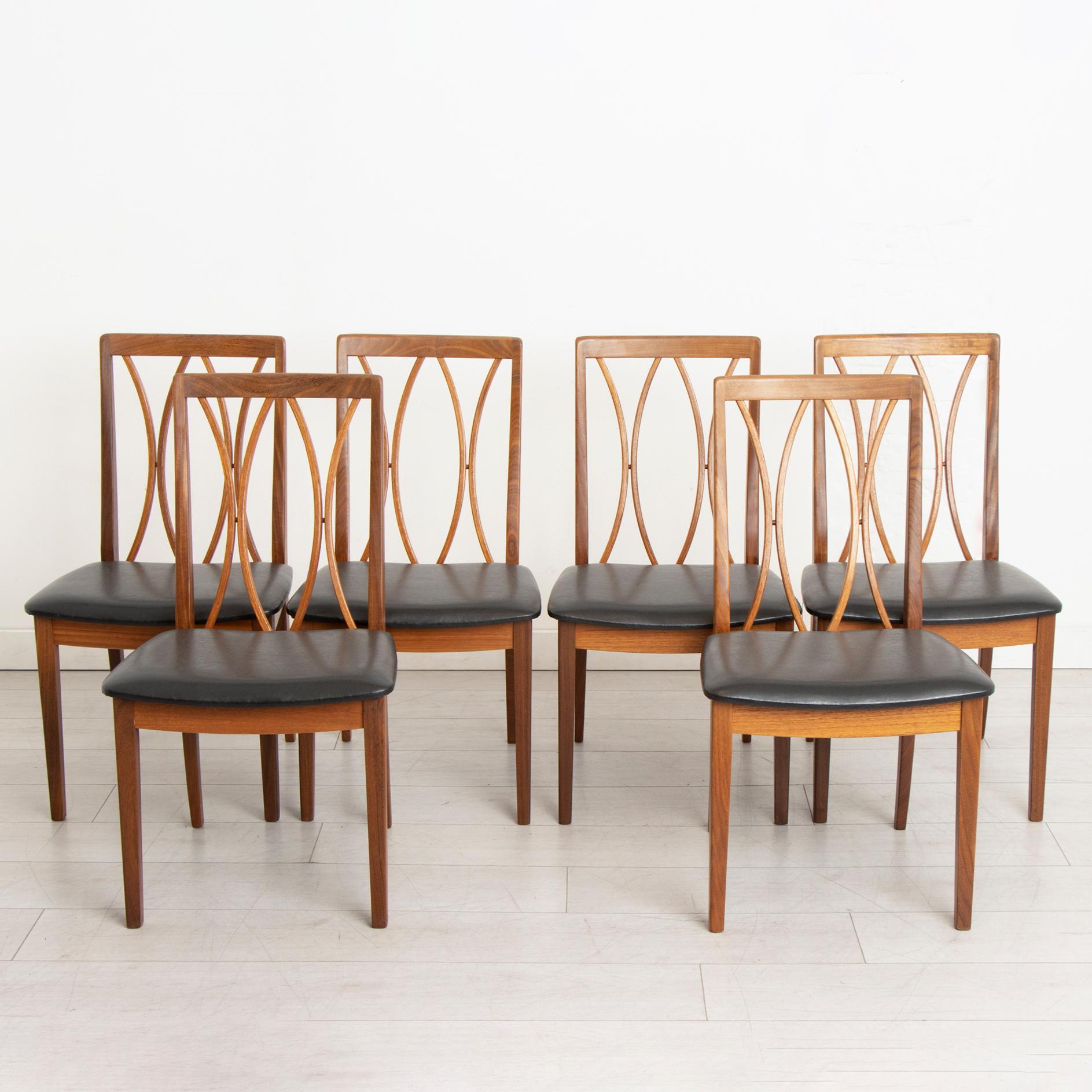 A set of six British mid-century dining chairs by G Plan from their Fresco range, circa 1960s. Newly reupholstered with premium black vinyl.