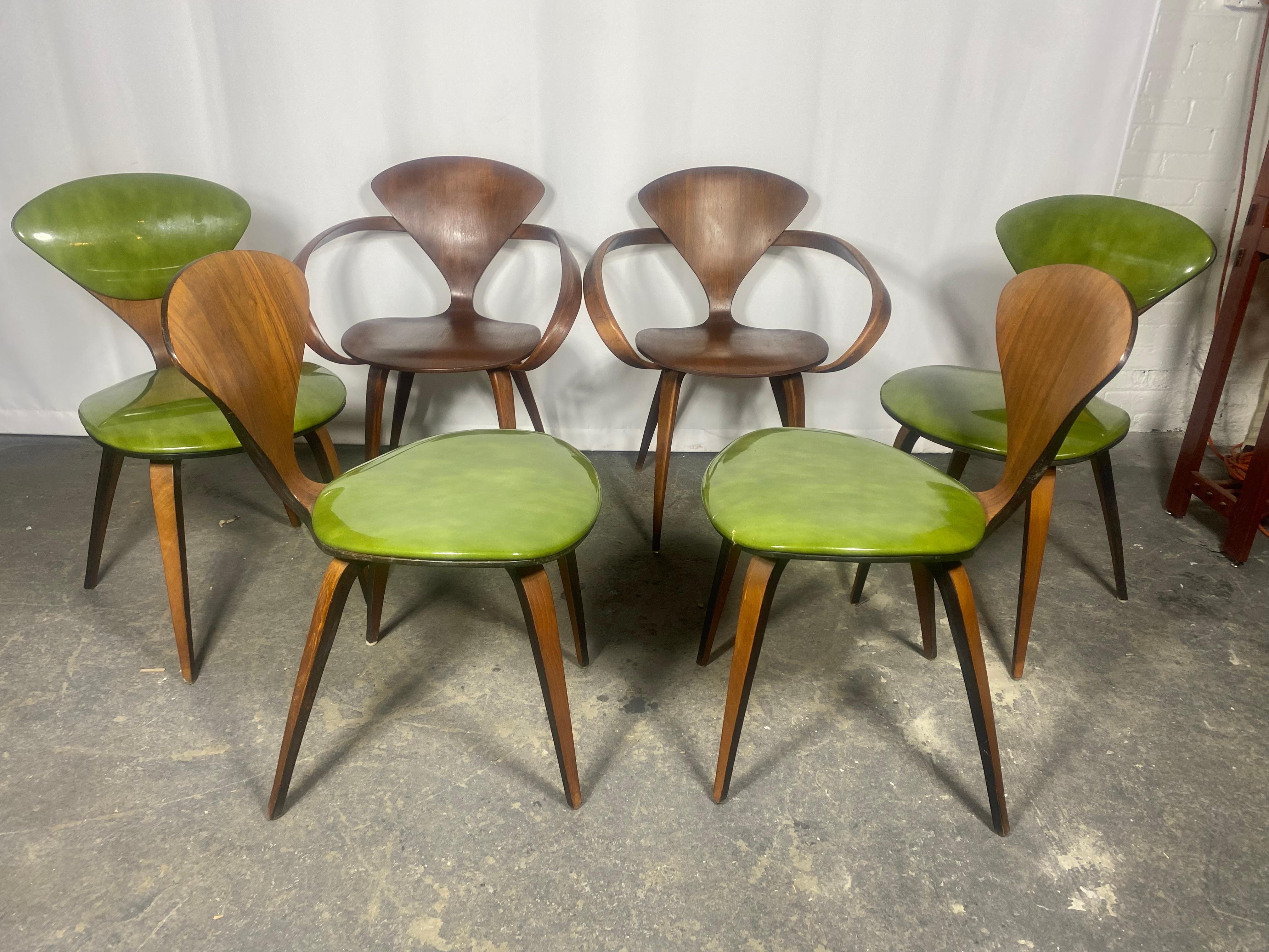 A set of six original Norman Cherner dining chairs, made by Plycraft, USA in the 1960s. Bentwood frames, original patent leatherl seats / backs  Plycraft labels to the undersides. This original set includes 2 Classic Pretzel arm chairs and 4 side
