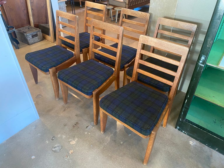 Set of six dining chairs by collectible French designers Guillerme et Chambron in stained oak with original upholstered seats.  More substantial and comfortable than other models.  France, 1950's