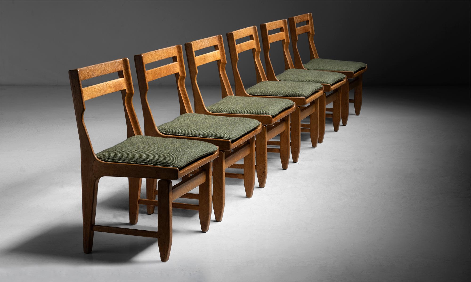 Set of (6) Oak dining chairs by Guillerme et Chambron

France circa 1960

Vintage frame with seat pads newly upholstered.

Measures: 19.25