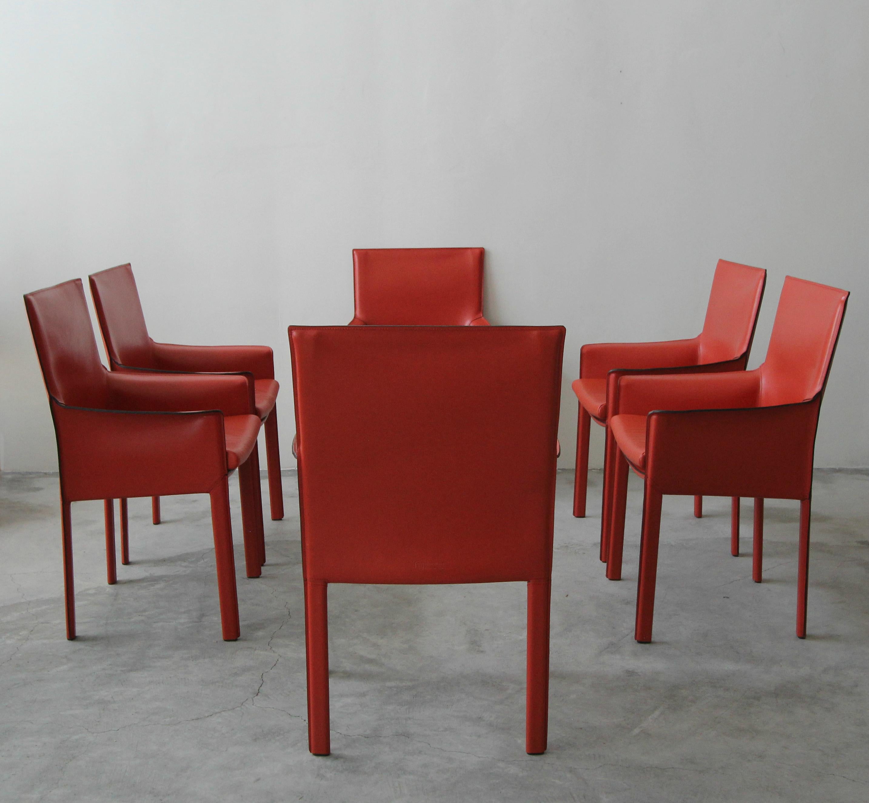 Gorgeous set of 6 Enrico Pellizzoni Pasqualina armchairs designed by Grassi & Bianchi. These chairs were custom ordered straight from Italy. They are covered in the most gorgeous shade of dark orange all grain leather. Chairs feature, rare vented