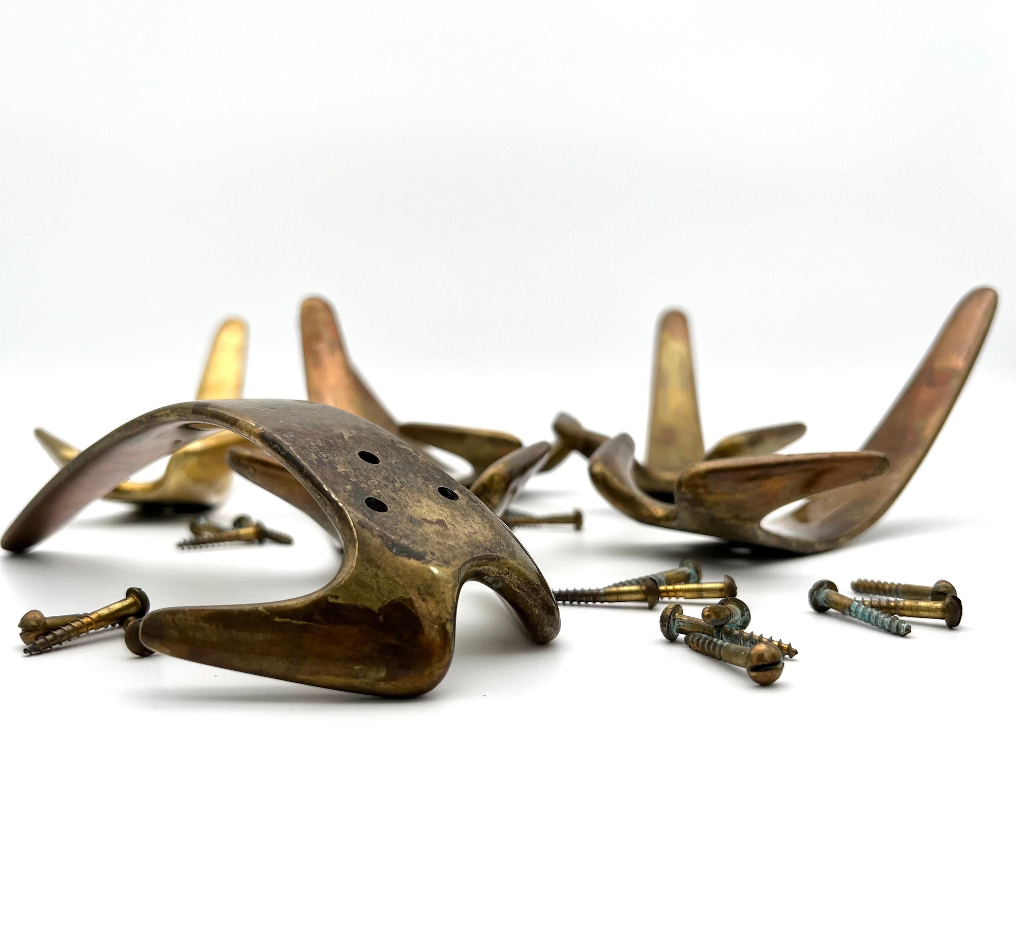 Set of 6 Original 50s Wardrobe hooks solid brass created by Carl Auböck.
Bought directly from an Viennese apartment, furnished in the year 1958. 
Original brass screws are included ! Nice patina, left as found.