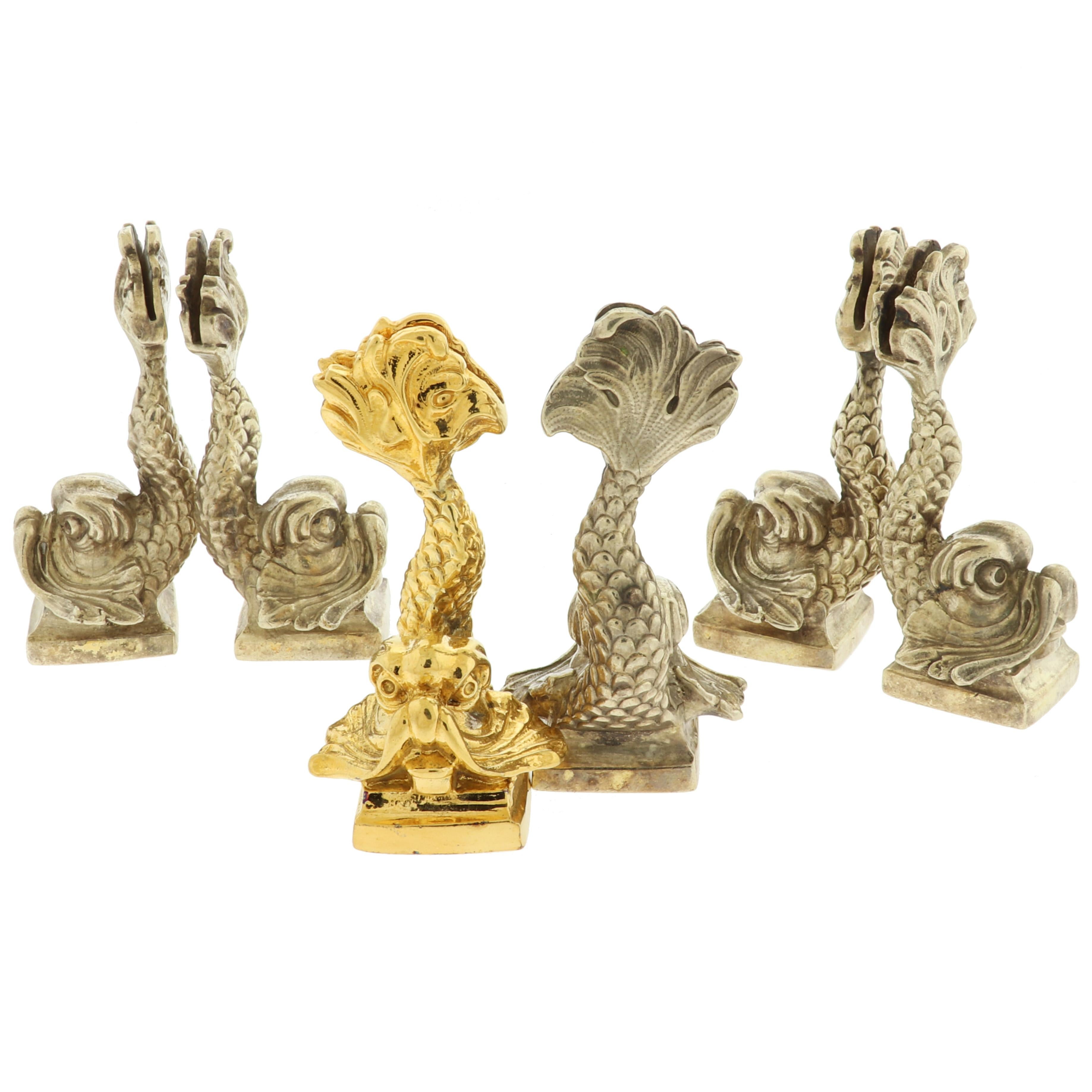 Ornate set of 6 sterling silver Koi Fish or Dolphin design dinner table place card holders. 

Crafted from solid sterling silver, these place card holders are remarkably detailed and will look effortlessly elegant on your dining room table.
