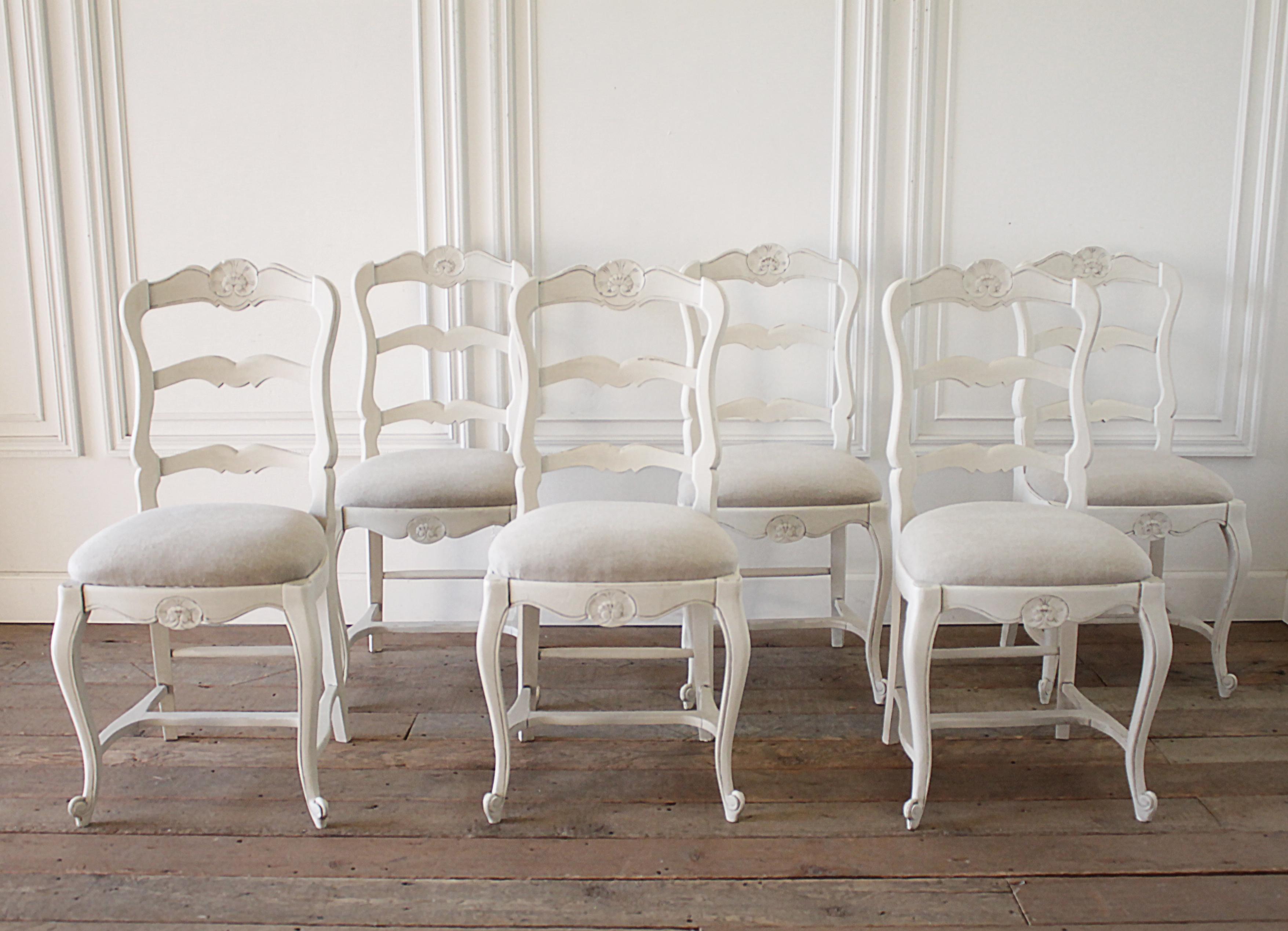 Set of 6 painted and upholstered French Country style dining chairs
Painted in a soft oyster white, with subtle distressed edges. The seats have brand new upholstery in our natural flax linen.
Each chair is solid and sturdy ready for everyday