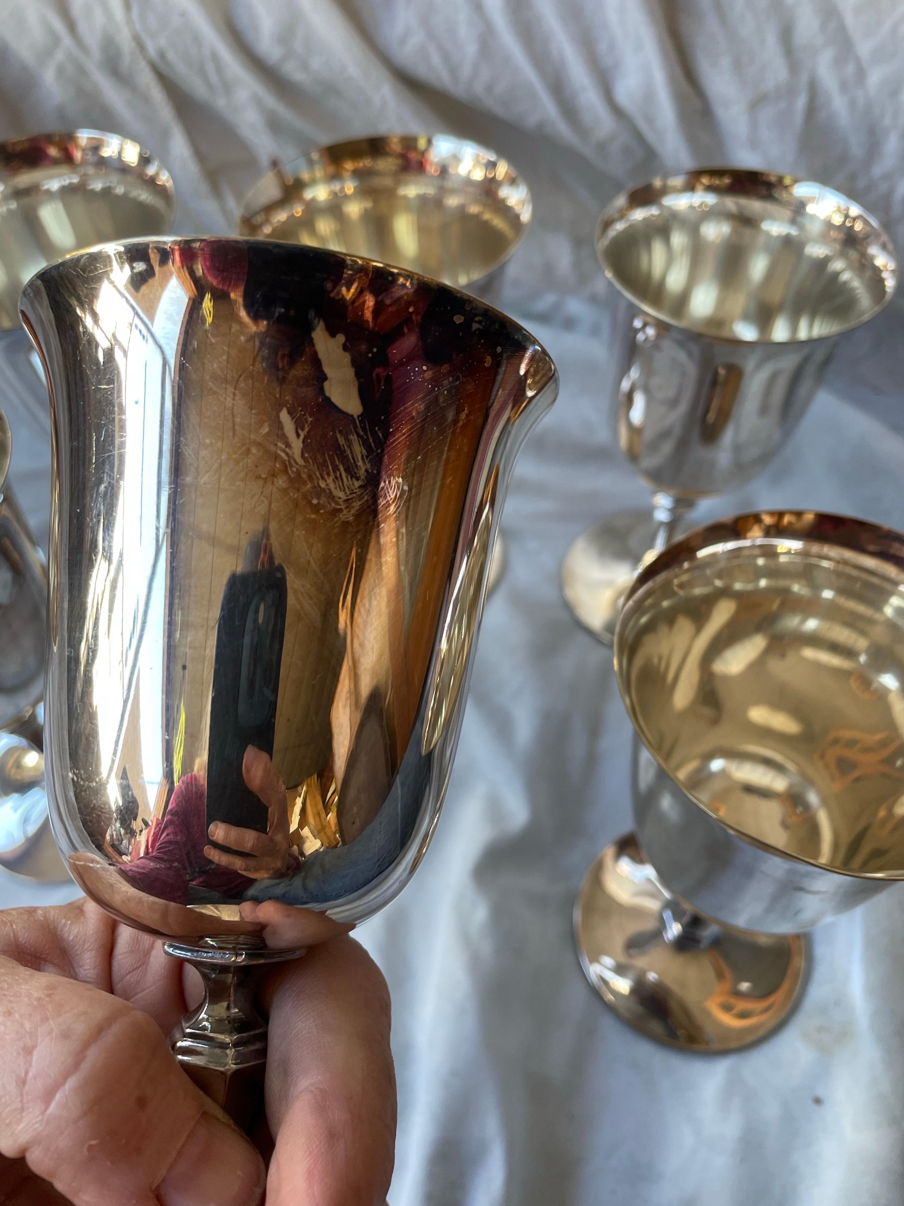 Here is an elegant and shiny set of 6 wine glasses or goblets made by the Pairpoint silver company in New Bedford Massachusetts. The goblets are in nice condition with only minor signs of use and wear and have a sweet shaped stem.

They are 6 inches