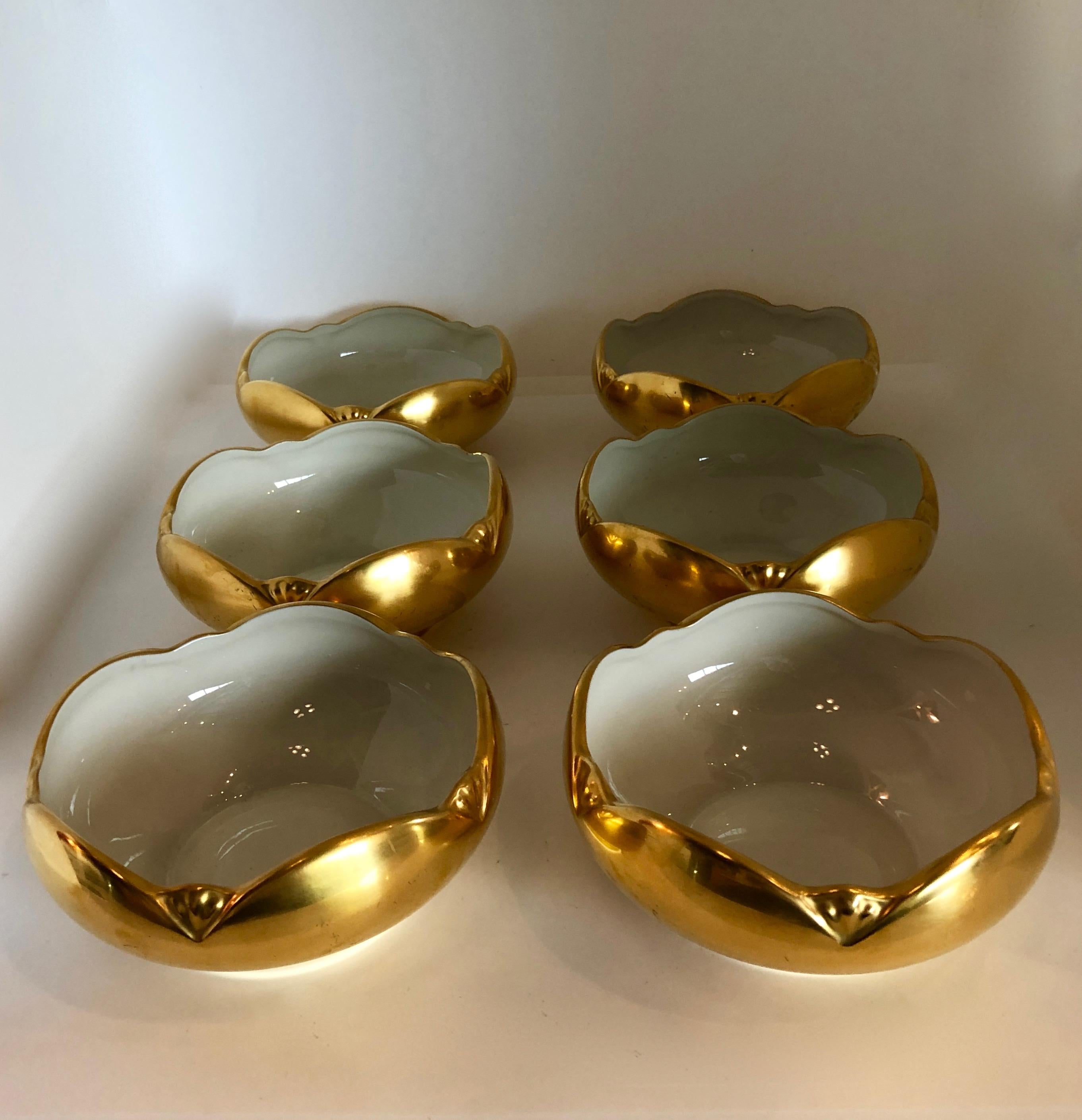 Offered is a Mid-Century Modern beyond gorgeous signed set of six Picard hand decorated ensemble gold exterior and white interior porcelain bowls. The set of six bowls are bone china that has been hand decorated with a gilt overlay. The bowls have a