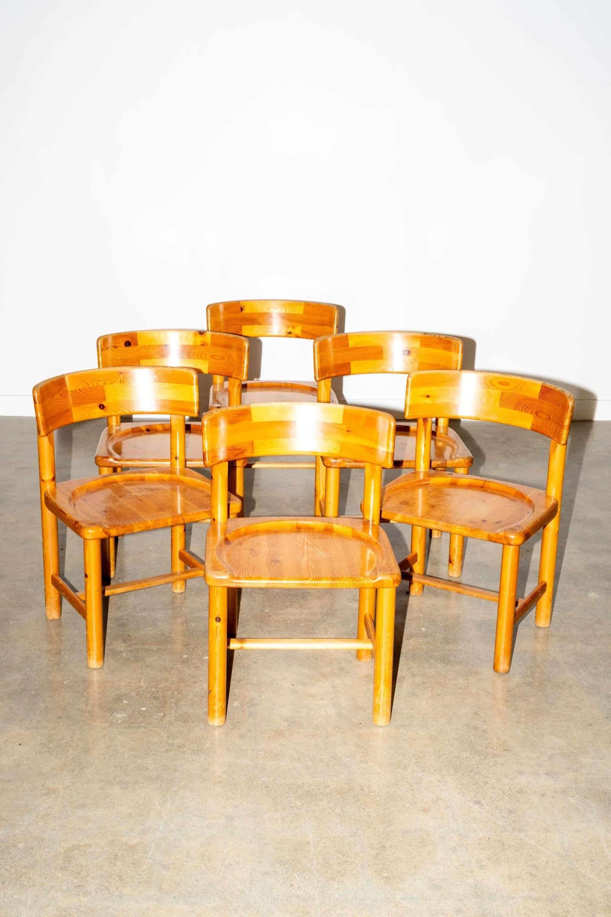 Charming in their simplicity, this set of six vintage pine chairs brings a warm, utilitarian beauty to the table. With rounded backs and visible knots, showcasing Daumiller's affection for pine, each piece leans into the rustic elegance of natural