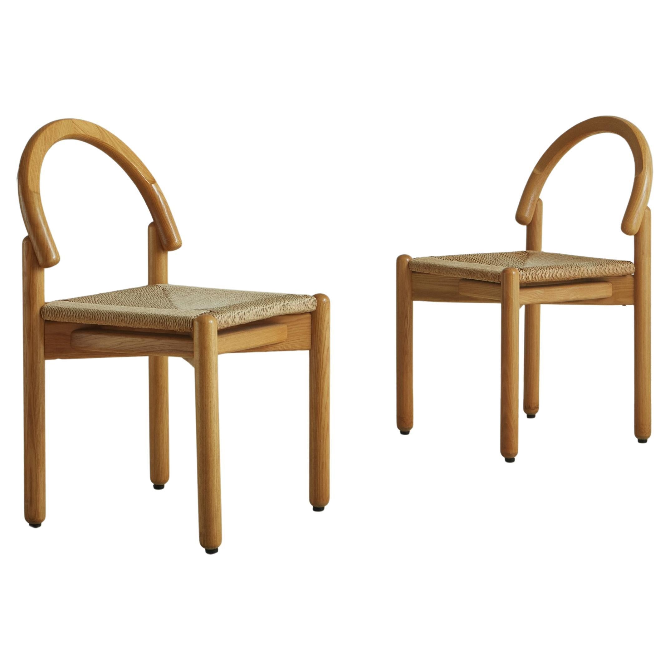 A set of 6 Mid Century dining chairs attributed to Argentinian designer Alberto Churba (b.1932). These chairs have pine wood frames and woven rope seats in a diagonal cross pattern. They feature a dramatically arched seat back, which is attached to
