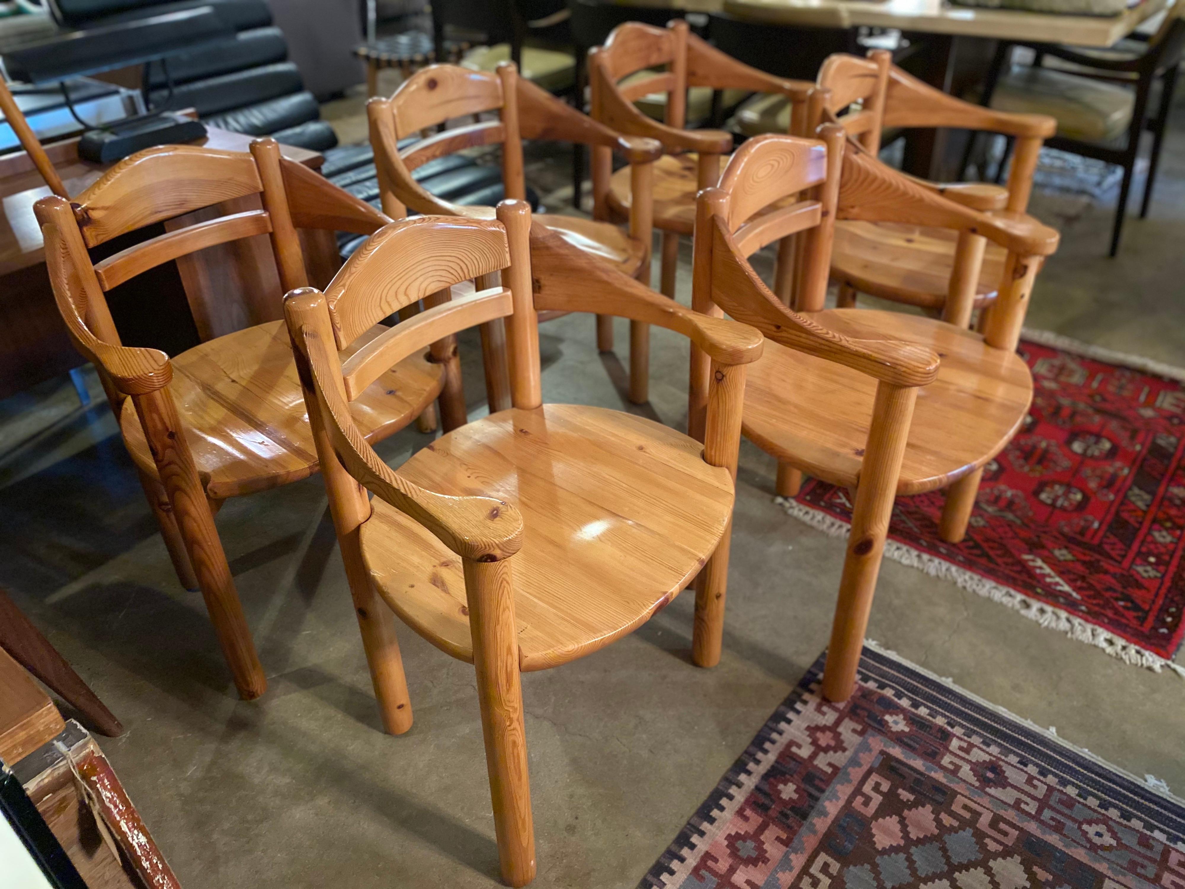Beautiful set of 6 solid pine dining chairs with armrests and a ladder back by Rainer Daumiller, circa 1970s. This set of Mid-Century Modern dining chairs are in overall great vintage condition. 

armrest height 27
