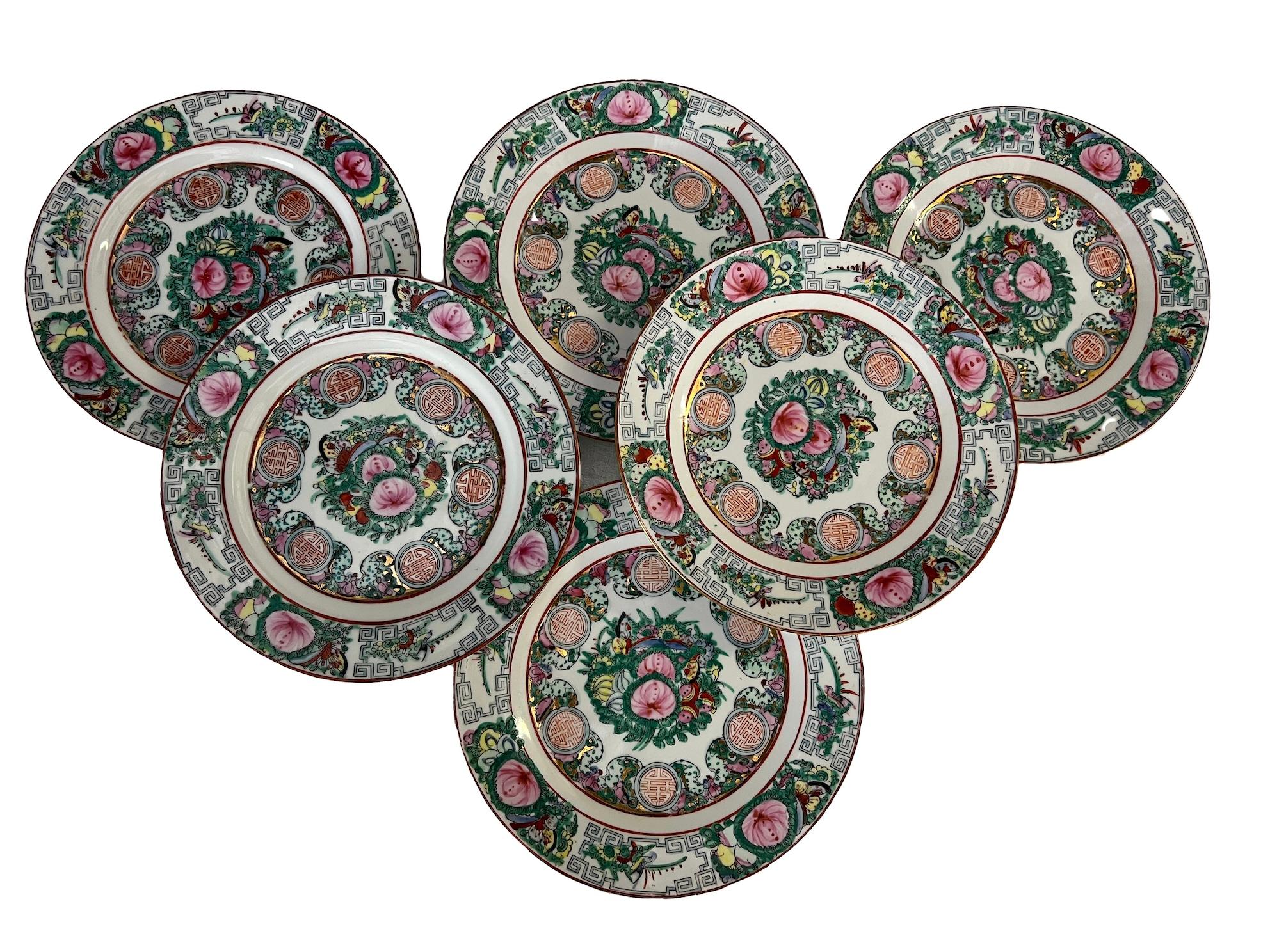 Set of 6 Chinese porcelain dessert plates. These Guang Cai plates, also known as 'three-color plates' or 'family rose plates' in Chinese, are a type of Chinese porcelain known for its vibrant color palette and intricate decoration. These plates are