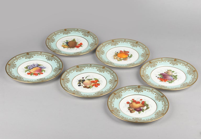 Beautiful set of six porcelain dinner plates, from the English brand Caverswall. The plates are decorated with different images of fruit and wide mint-coloured rims. The plates are decorated with elegant gold decorations. The plates are in very good