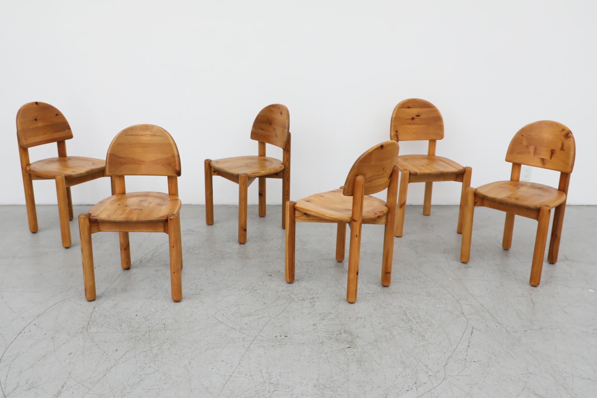 Set of 6, mid century, Rainer Daumiller designed, solid pine dining chairs with attractive half moon backrests. Lightly refinished with some visible wear consistent with its age and use. One chair has an old crack in the back rest that was repaired