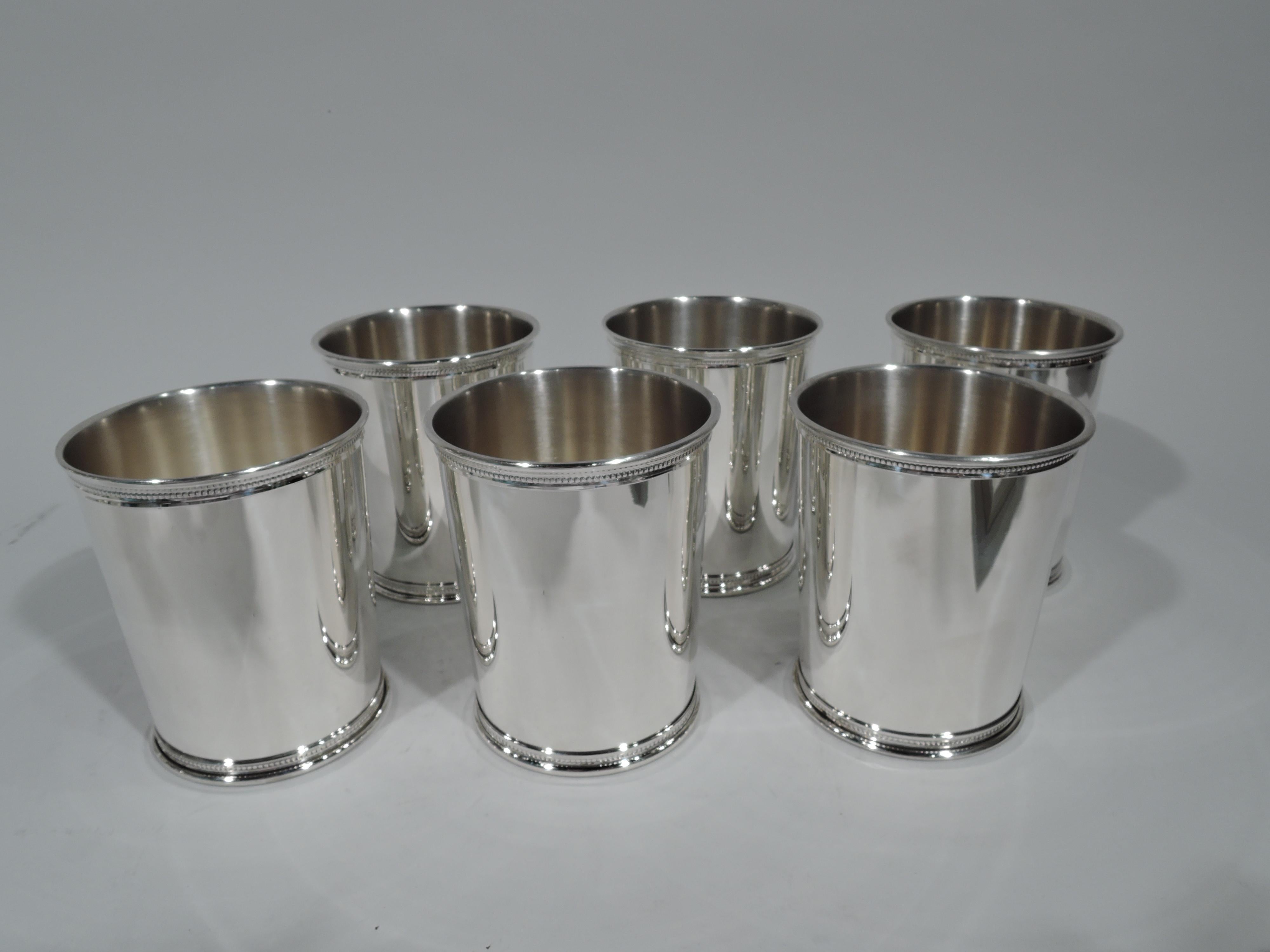 Set of 6 sterling silver mint julep cups. Made by Reed & Barton in Taunton, mass. Each: Straight and tapering sides and beaded rim and foot. Hallmark includes no. X253 and presidential date code JEC for James Earl Carter (1977-1981). Total weight: