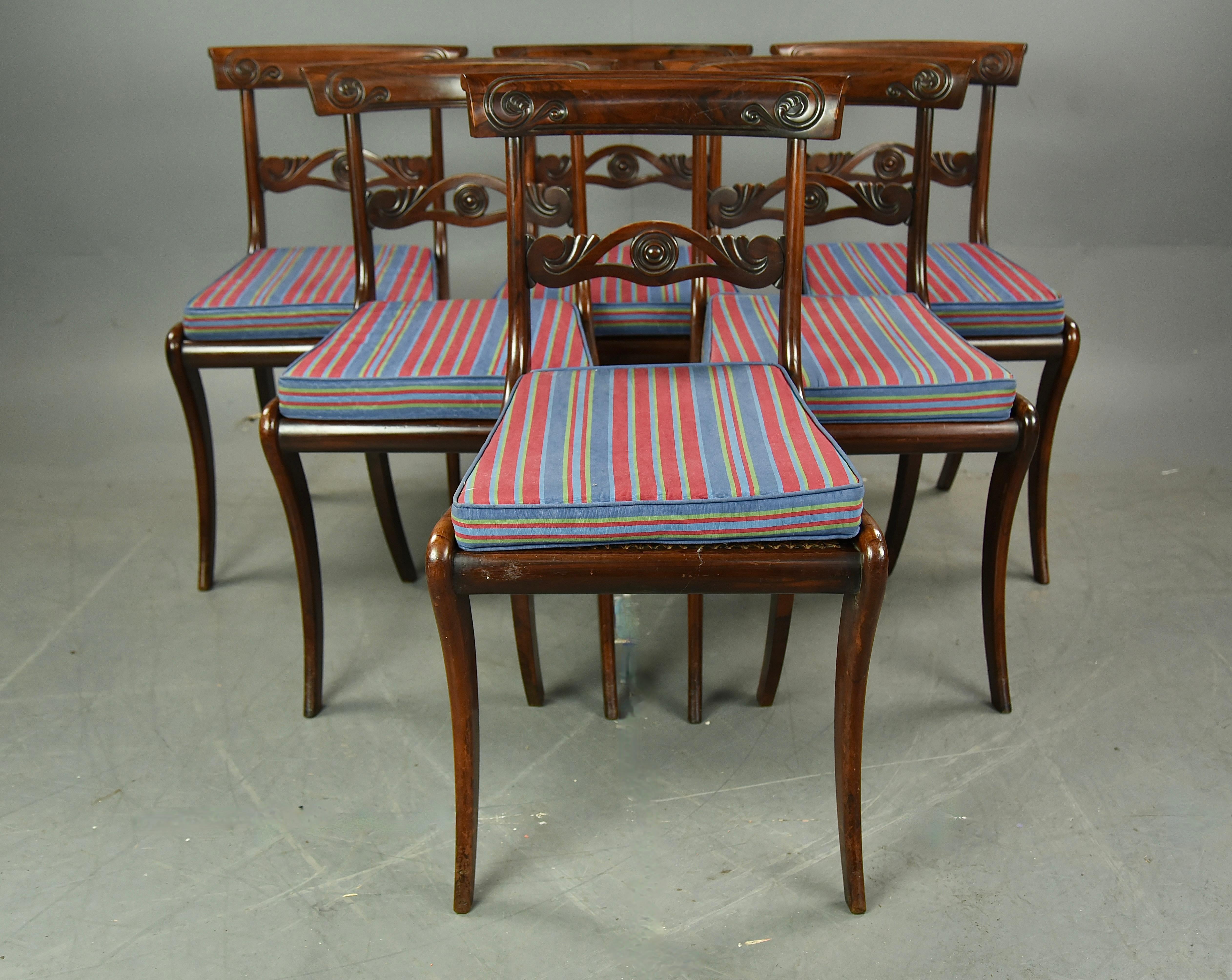 Fabulous set of six Regency rosewood dining chairs circa 1820 .
The chairs are in very good condition and are all solid in joint .
They are constructed of solid rosewood through out with well figured hand carved back rails .
The cane seats are all