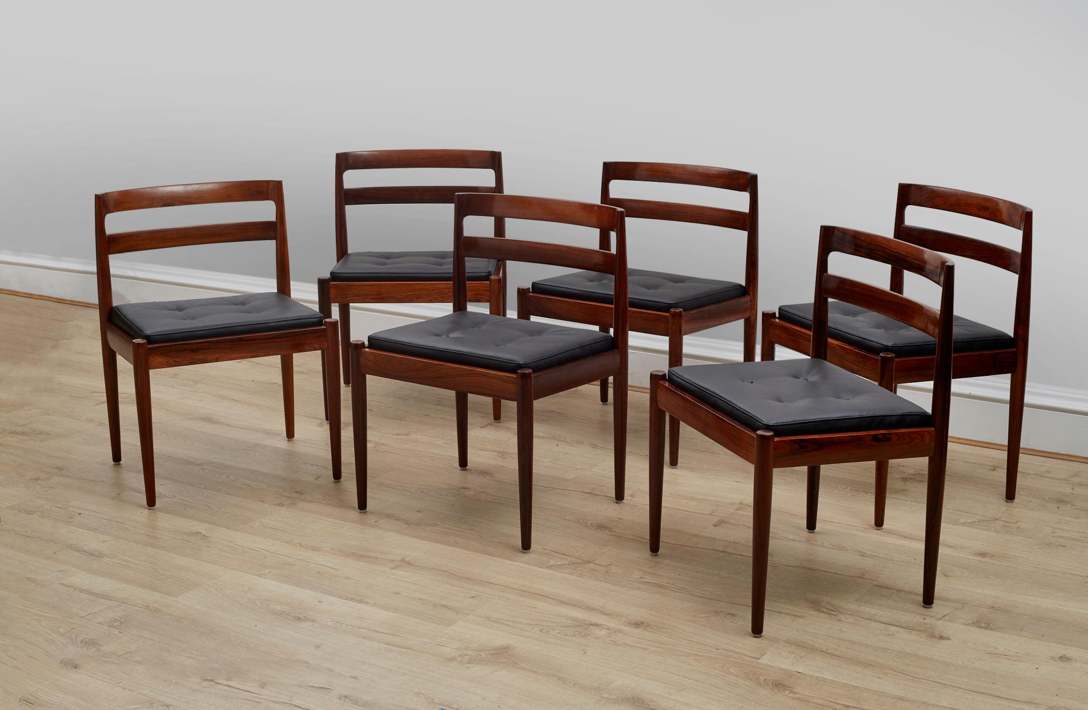 A stunning set of 6 model 301 Danish dining chairs by Kai Kristiansen in solid rosewood. This was made in Denmark by Magnus Olsen and dates from the 1960’s.

These are a rare and top quality model, with an inset removable leather cushion. The frame