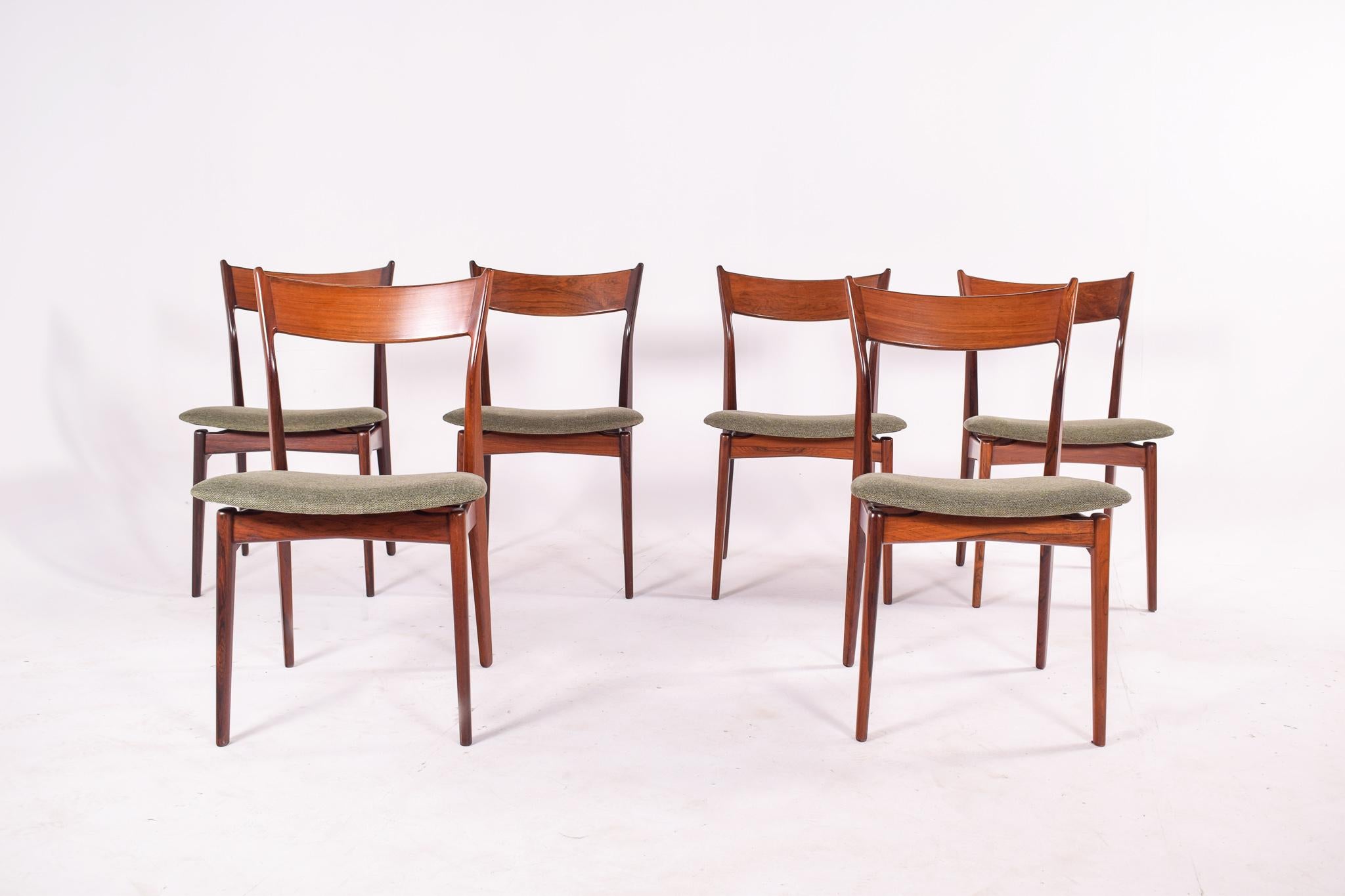 A wonderful set of 6 Danish rosewood dining chairs by HP Hansen. Newly upholstered seats in green wool textile.