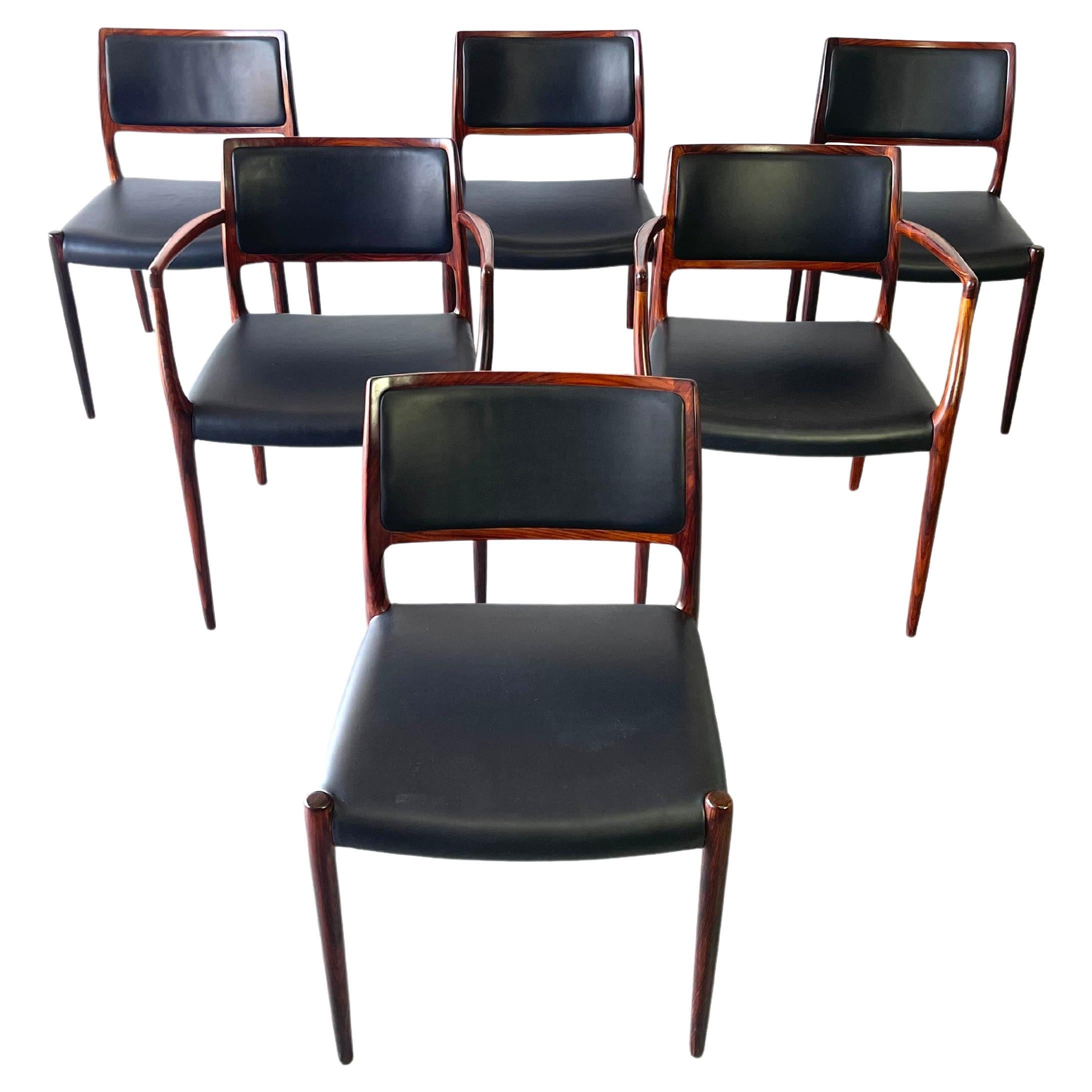 Set of six dining chairs in rosewood by Niels Otto Møller for J.L. Møllers Møbelfabrik. Two Model 65 captains/arm chairs and four Model 80. Side chairs. All chairs display Niels Otto Møllers characteristic organic shapes and the high standard of