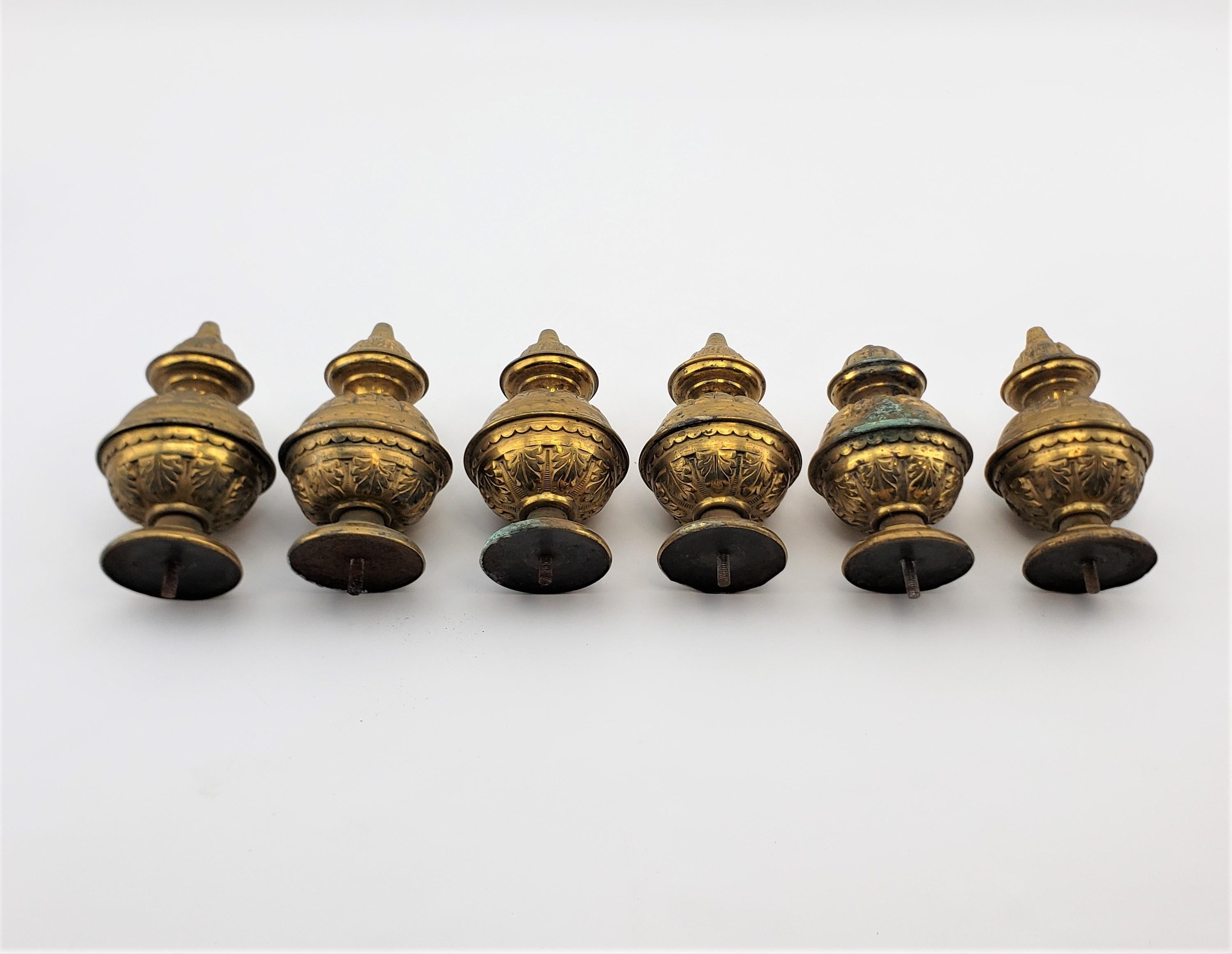 This set of six antique brass finials are unsigned, but presumed to have originated from the United States in circa 1890 in a period Victorian style. The finials are matching, although one is slightly shorter, and done in hollow brass with raised