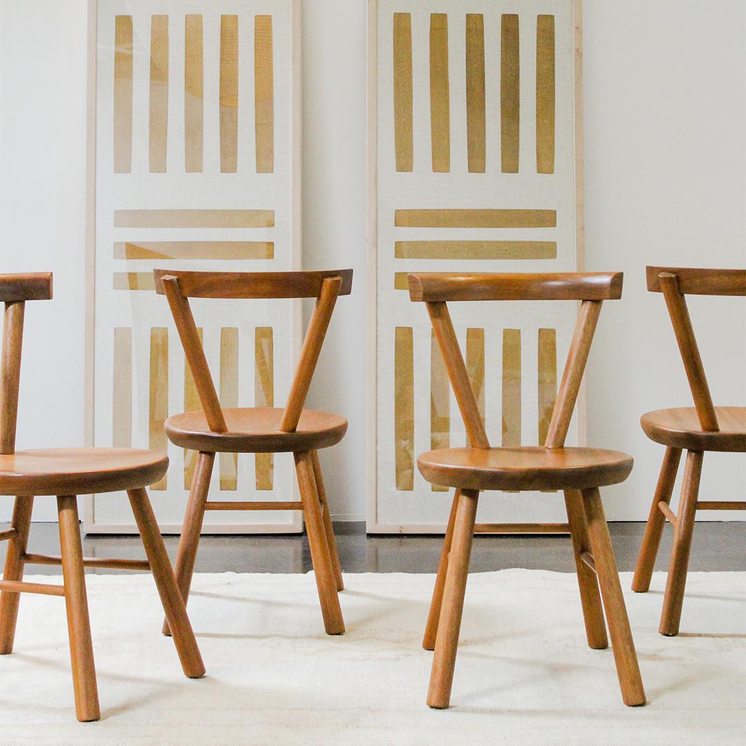 A set of six 1970s sculptural dining chairs in the style of Charlotte Perriand. This design took inspiration from Perriand's tripode chair no.20 from the 1950s.