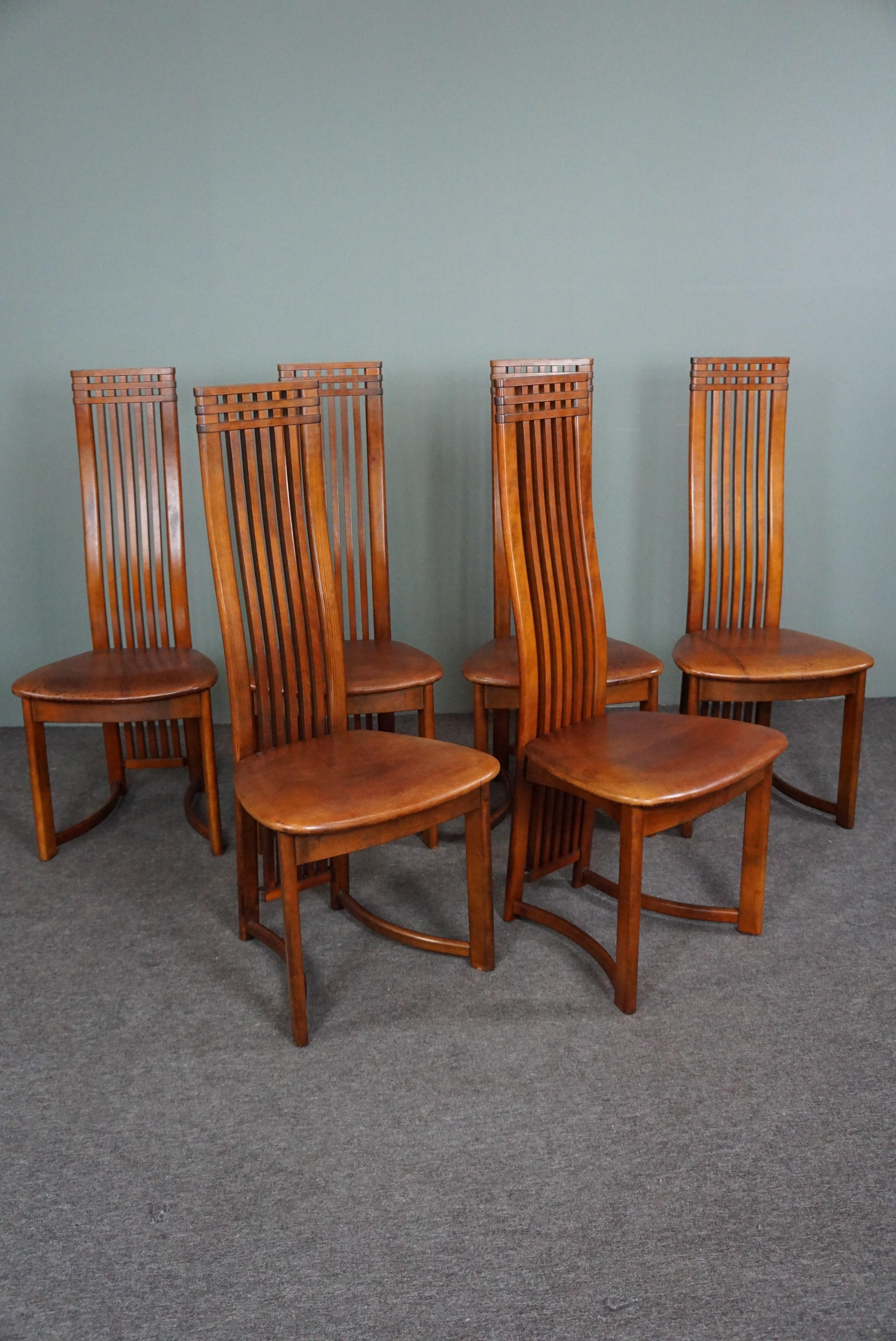 Offered is this set of 6 beautiful dining room chairs with sheep leather seats.
Is it the combination of the sheep leather and the high wooden backrest, or is it the design and appearance that make these chairs so striking? What we do know is that
