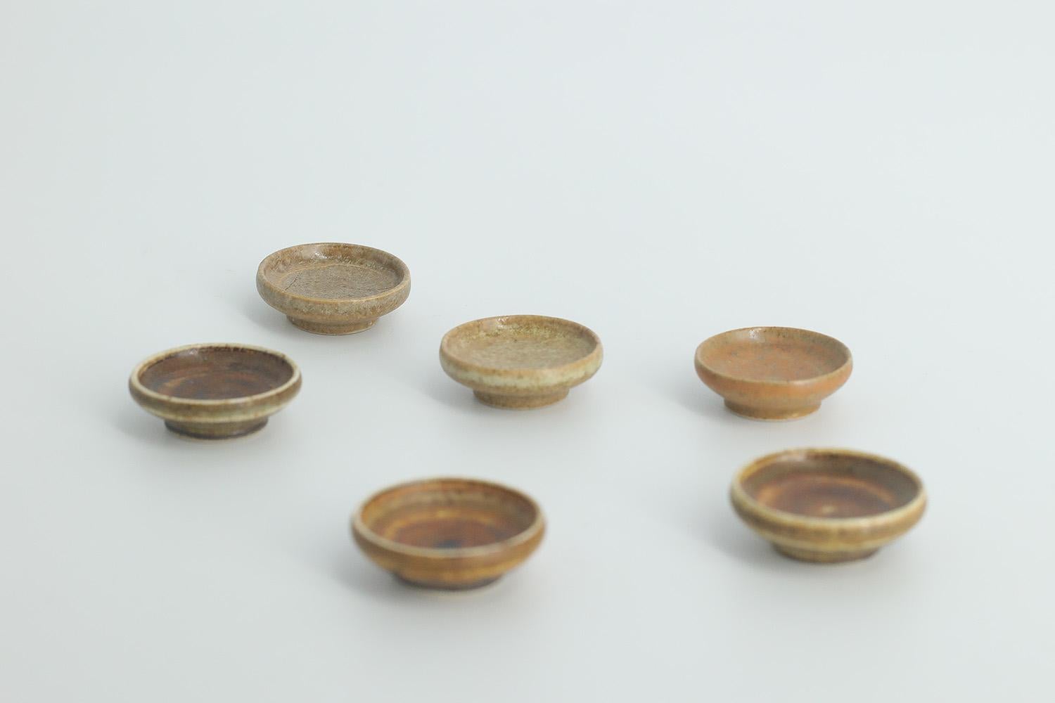 This set of 6 miniature bowls was designed by Gunnar Borg for the Swedish manufacture Höganäs Keramik during the 1960s. Handmade by the Master, with the utmost care and attention to detail. Bowls dyed in an irregular shade of brown. Signed with the