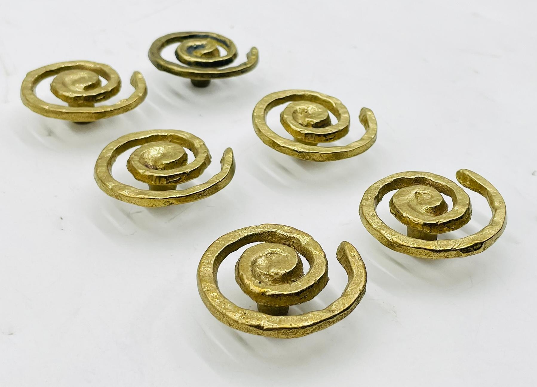 Add a touch of vintage charm to your cabinets with this set of 6 Solid Brass Cabinet Pulls from Mexico, dating back to the 1950s. Each pull features a unique spiral design, crafted from hammered brass for a durable and stylish finish. 
These pulls