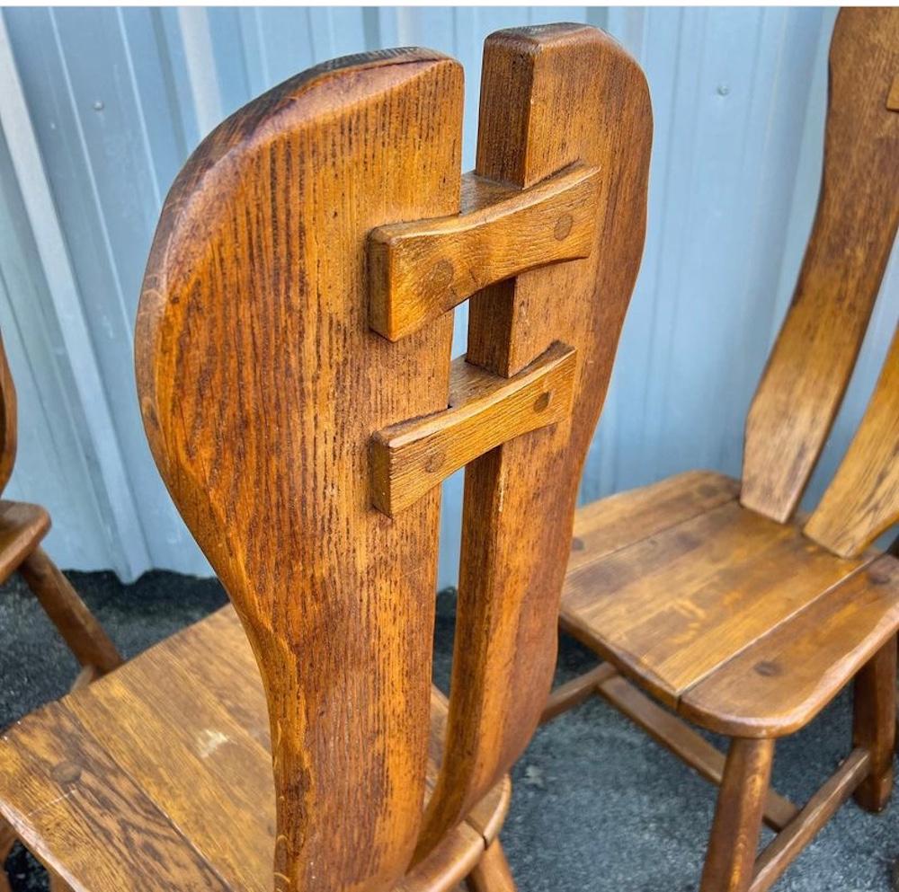 Beautiful set of six solid oak brutalist dining chairs by Kunstmeubelen De Puydt, circa 1960s, Belgium. This set of six Scandinavian modern dining chairs features a dark brown color with a sculptural high back that is curved and is in great overall