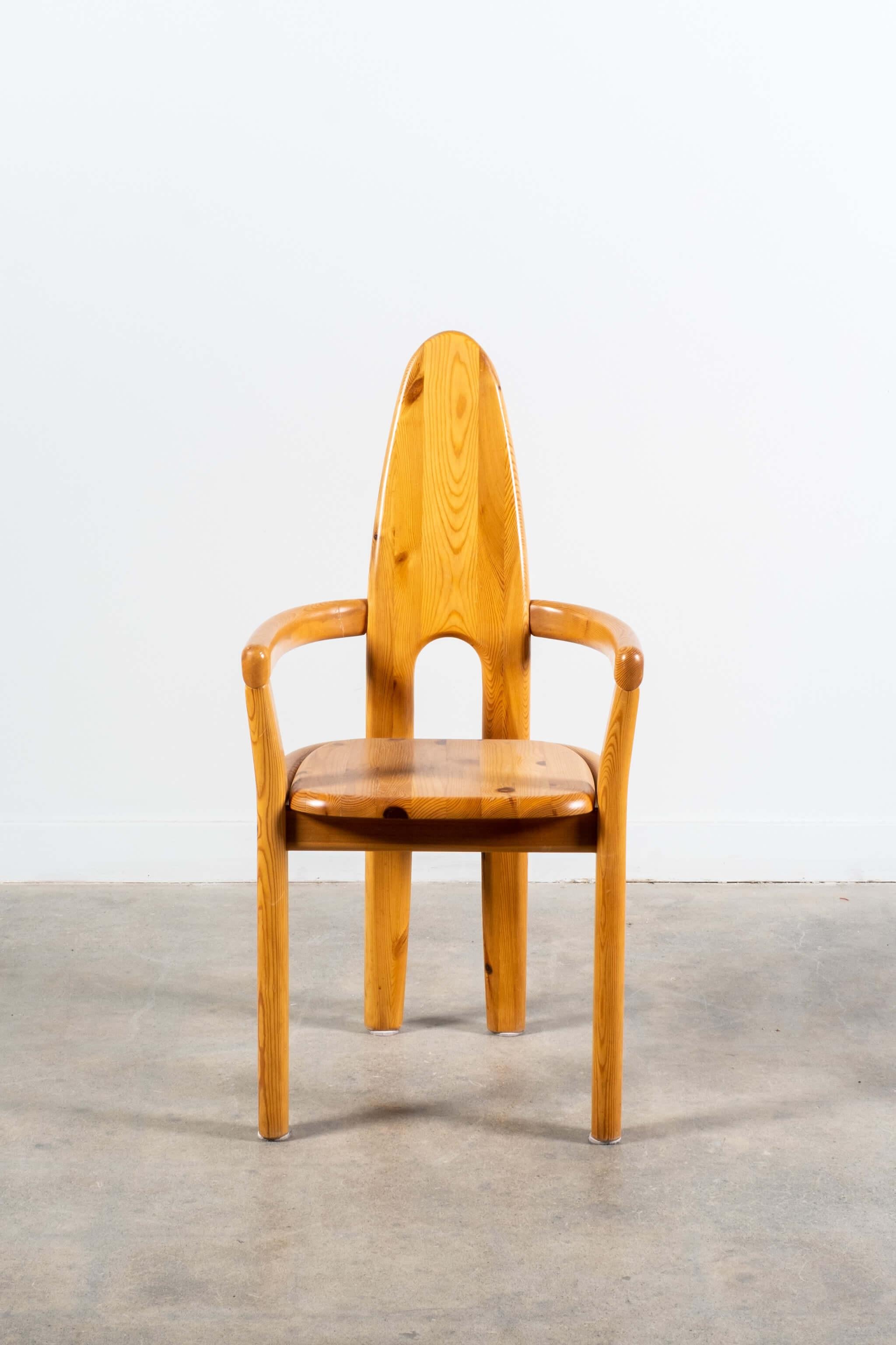 This rare set of chairs by German-born designer Rainer Daumiller exhibits a sculptural high back of solid pine. Solid in construction, simple in form, and sculptural in expression, their straightforward materiality and robust composition pay tribute